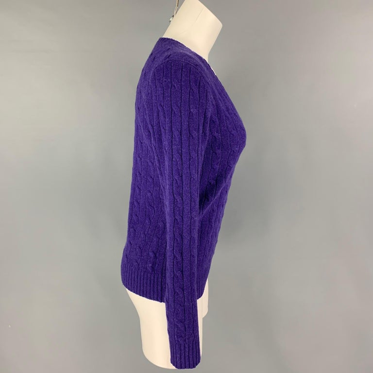 POLO by RALPH LAUREN sweater comes in a purple cable knit cashmere featuring a v-neck. 

Very Good Pre-Owned Condition.
Marked: M

Measurements:

Shoulder: 17 in.
Bust: 34 in.
Sleeve: 26.5 in.
Length: 23.5 in. 