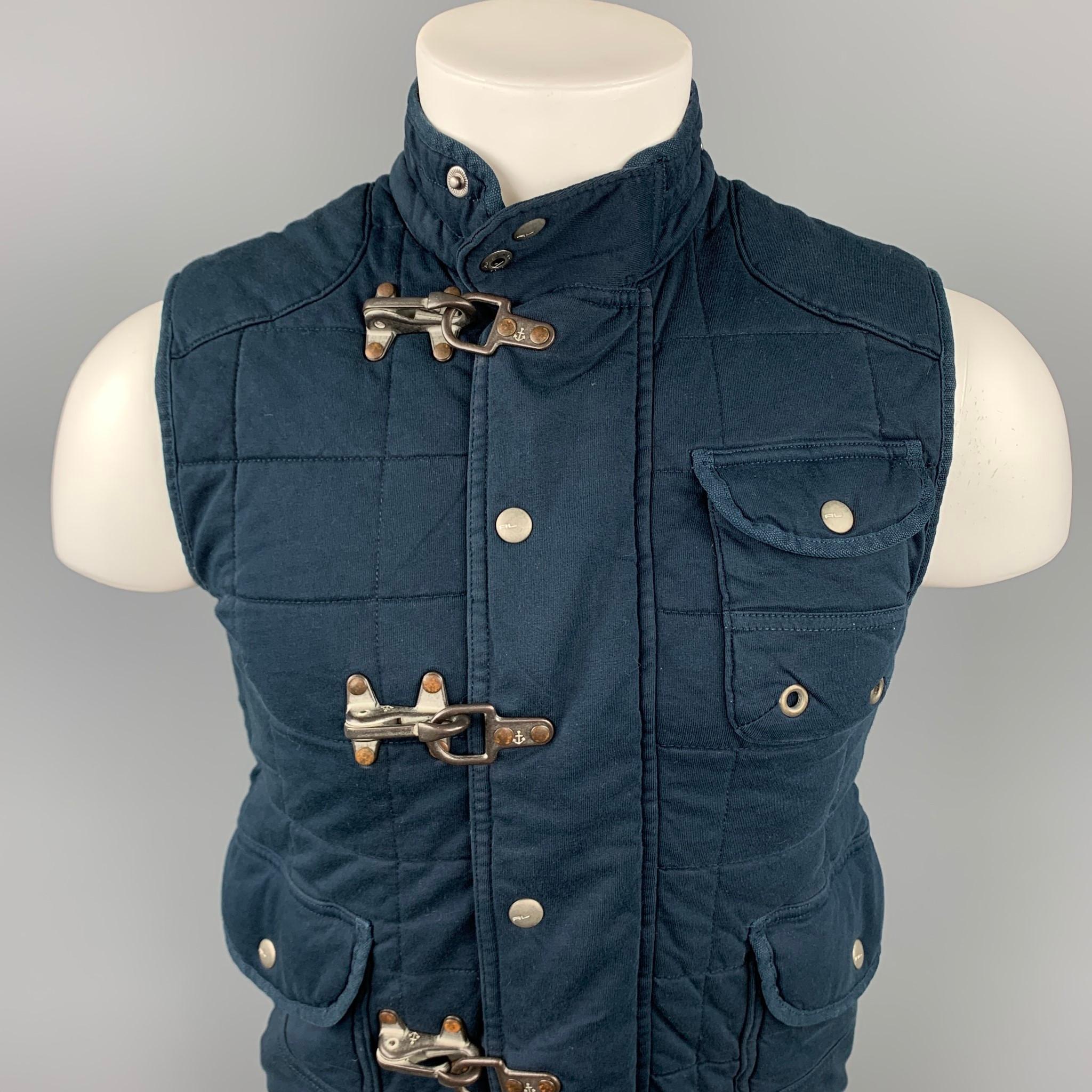 POLO by RALPH LAUREN vest comes in a navy quilted cotton featuring a nautical style, front patch pockets, hook & loop, and zip up closure.

Good Pre-Owned Condition.
Marked: S

Measurements:

Shoulder: 15.5 in.
Chest: 34 in.
Length: 22 in. 