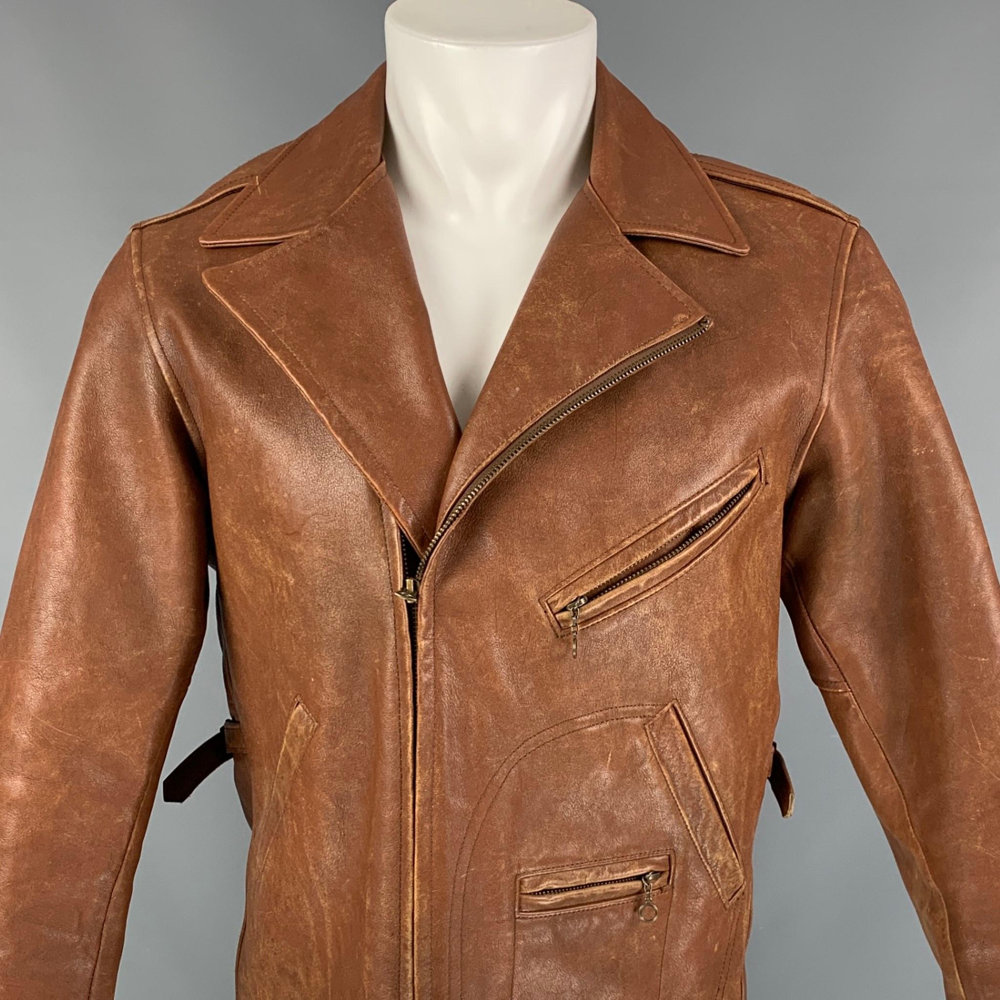 POLO by RALPH LAUREN jacket comes in a tan distressed leather with a quilted liner featuring a biker style, front pockets, side tabs, buckle strap sleeve details, and a full zip up closure. 

Very Good Pre-Owned Condition.
Marked: