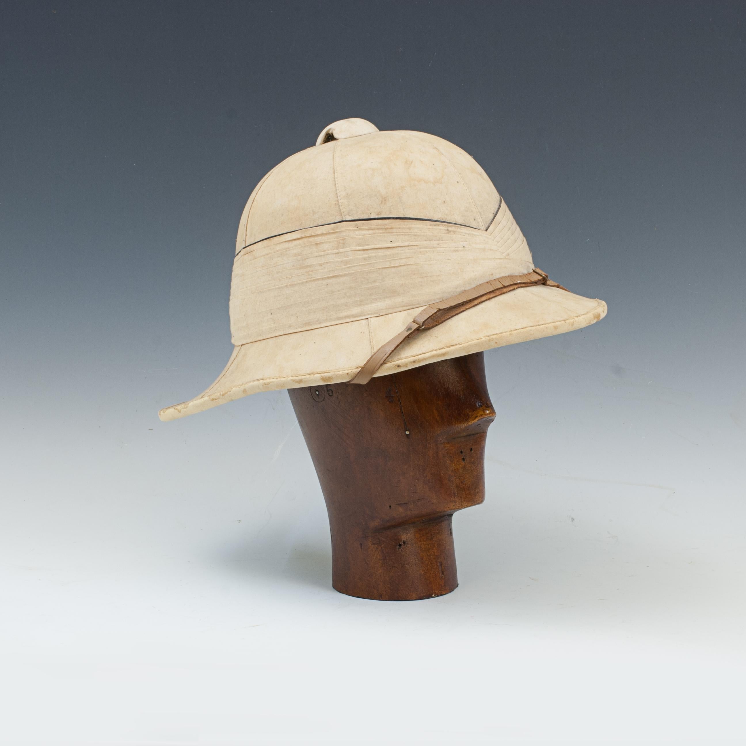 Gieves Royal Navy Officer's Tropical Helmet, Pith Helmet, Solar Topee.
A good Gieves Ltd. 'Wolseley pattern' solar topee (also known as a pith helmet, safari helmet, sun helmet or solar topi). The cork sun hat is a lightweight cloth-covered helmet