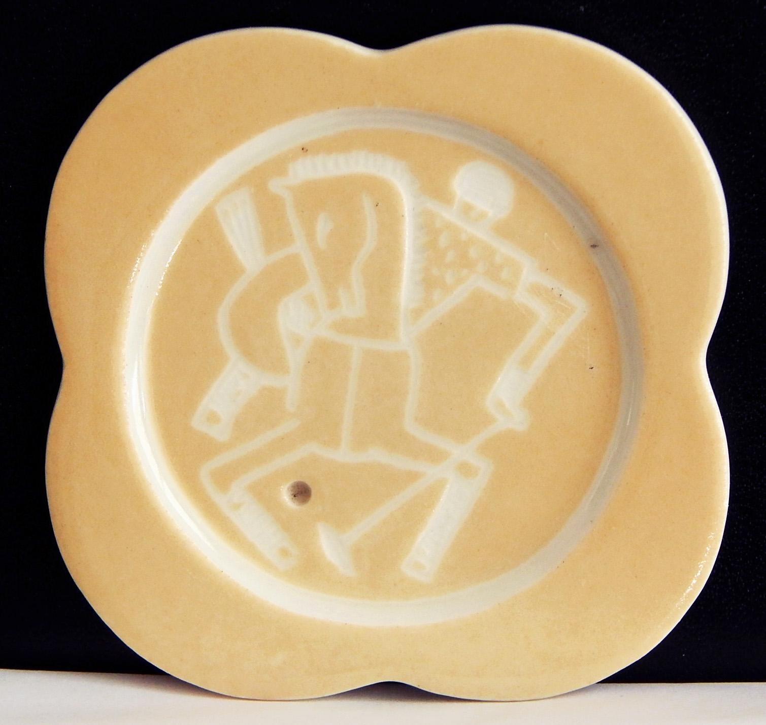 Strikingly sculpted, incised and glazed, this very rare set of five coasters depicting polo players upon their horses -- each of them unique and incised by Gregory's hand -- is glazed in white and a warm, golden putty hue.  Gregory was famous for