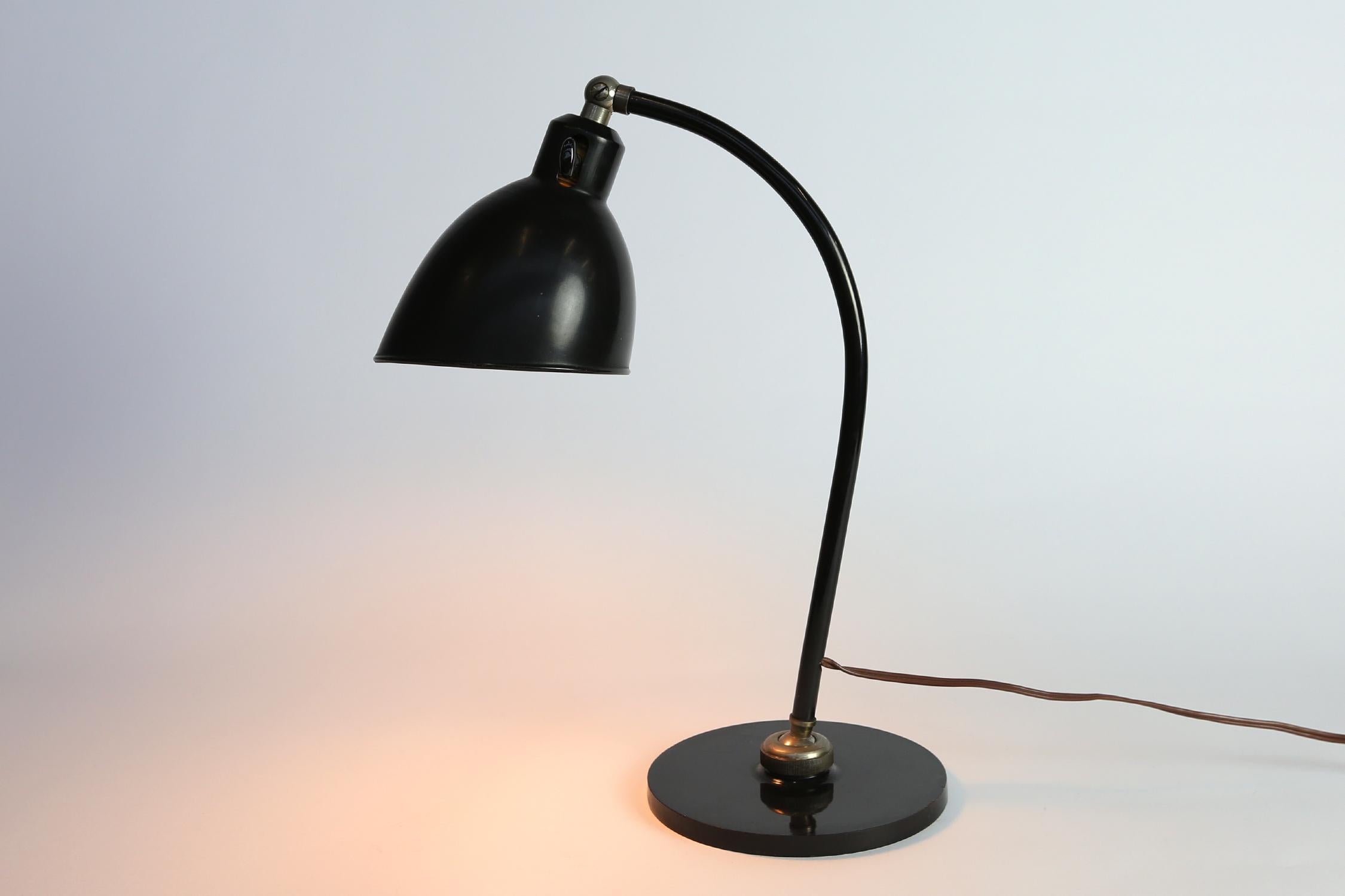 A fine and original Christian Dell light. Black painted metal with adjustable arm and base. Marked Polo Popular on the base, in working condition.