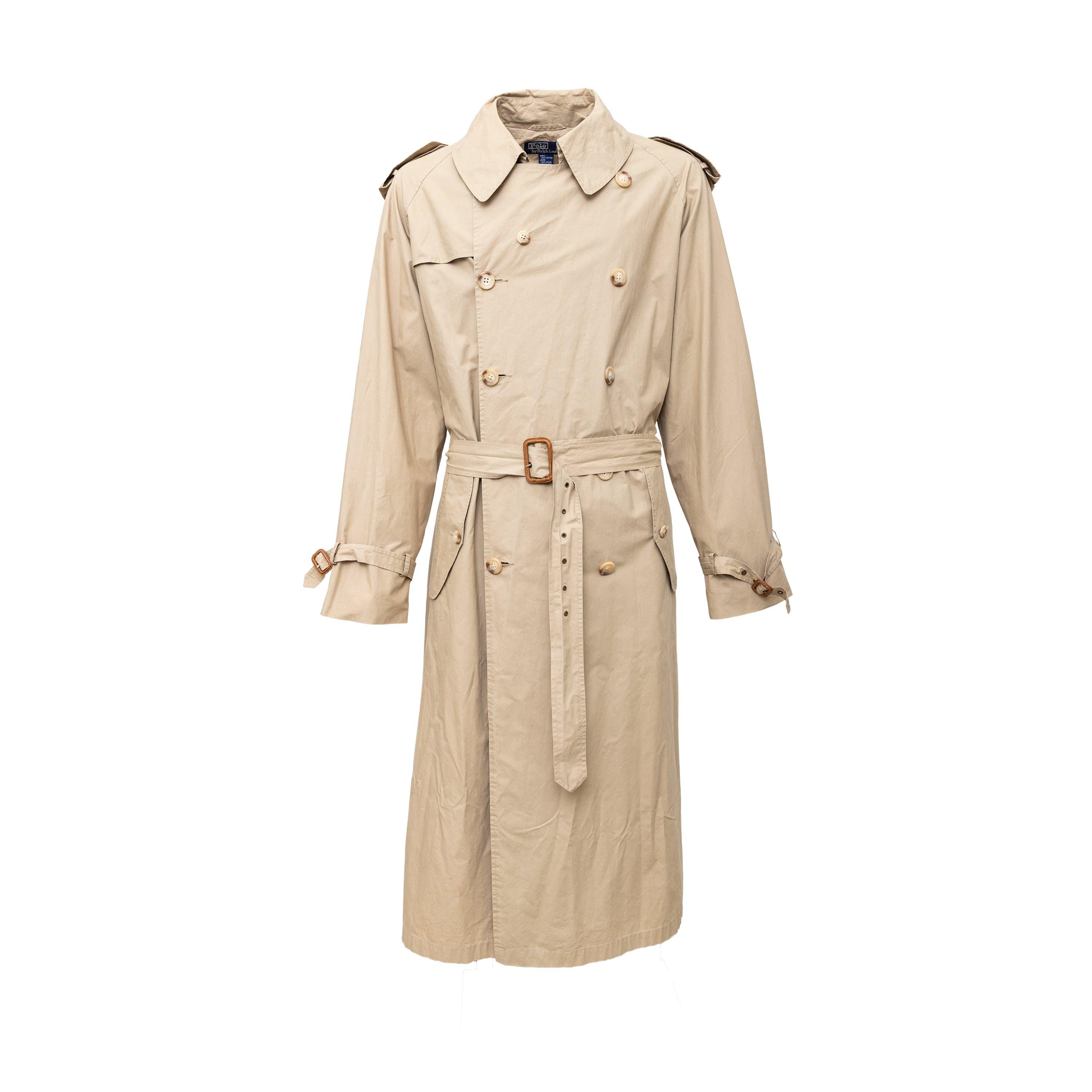 This Polo Ralph Lauren trench coat boasts a classic double-breasted silhouette, leather-covered buckles, and an adjustable buckled belt at the waist. The cotton exterior and nylon lining in khaki brown offer a timeless style that is both functional