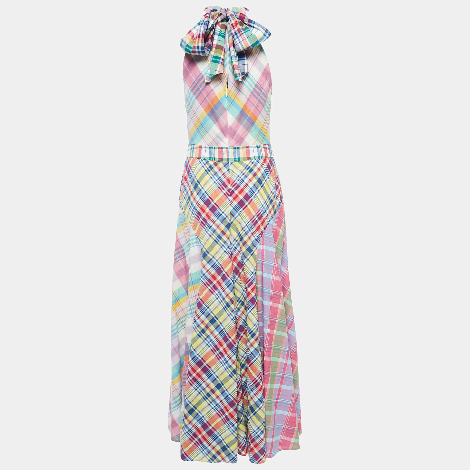 The Polo Ralph Lauren dress is a vibrant and chic summer essential. Crafted from high-quality cotton, its playful multicolored check pattern exudes a timeless charm. The halterneck design adds a touch of sophistication, making it a perfect blend of