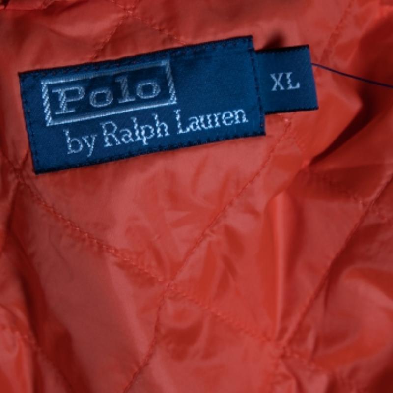 This Polo Ralph Lauren bomber jacket comes in attractive orange color. Highly durable it is quilted in polyester, has two patch pockets on front, buttoned closure, and defined neckline. Pair this long-sleeved jacket with black or khaki chinos.