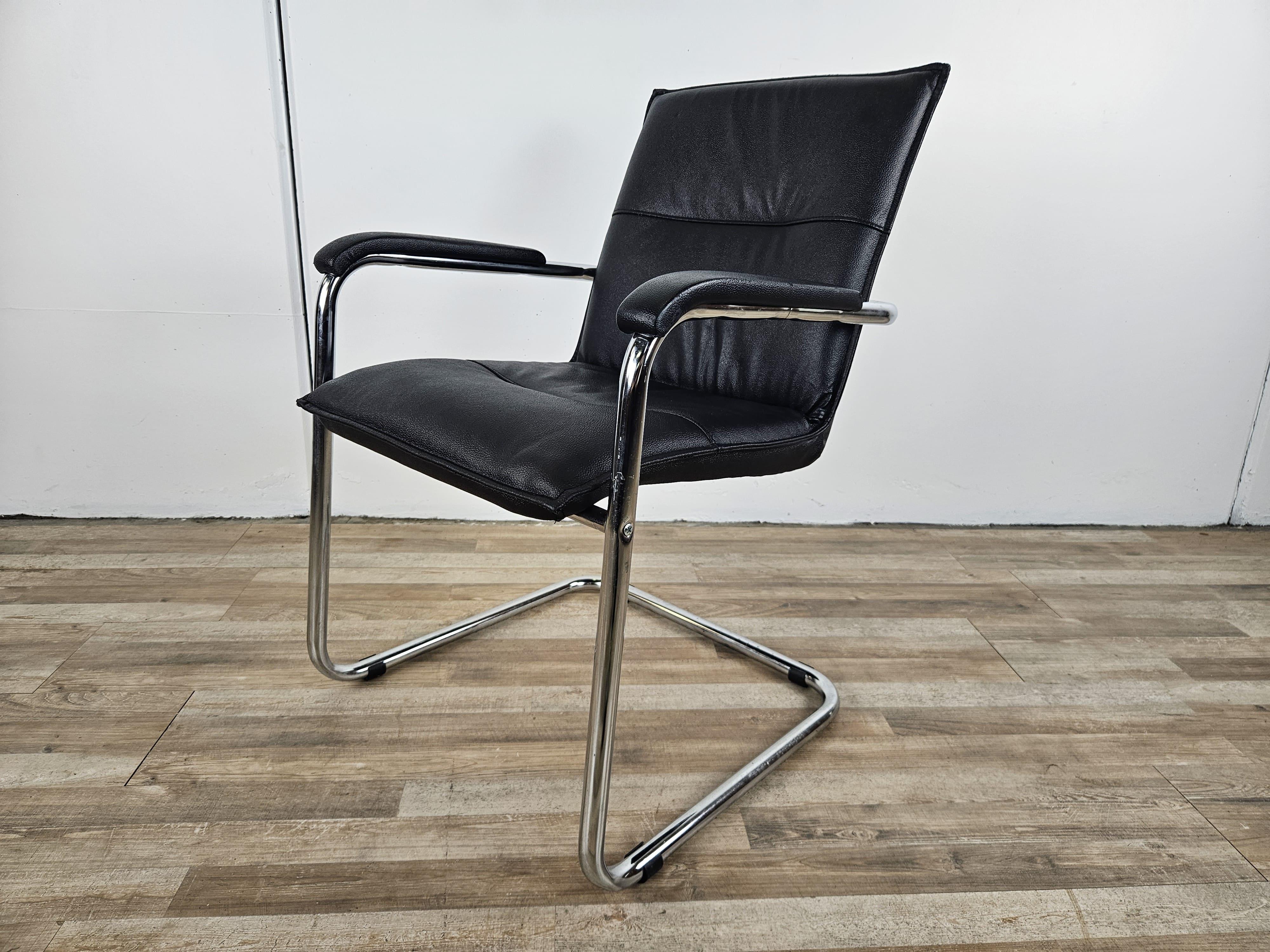 Industrial 1970s armchair made of tubular steel and black faux leather For Sale