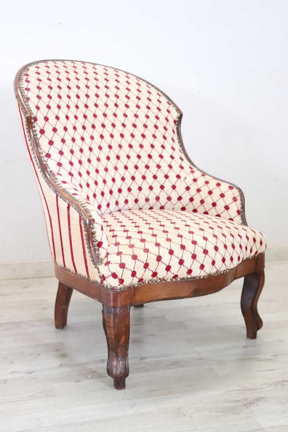 Delicious small antique Italian armchair from the mid-19th century. Made of solid walnut wood. Small size very comfortable and enveloping with padded backrest. These small armchairs were used to decorate bedrooms. Good general condition, signs of