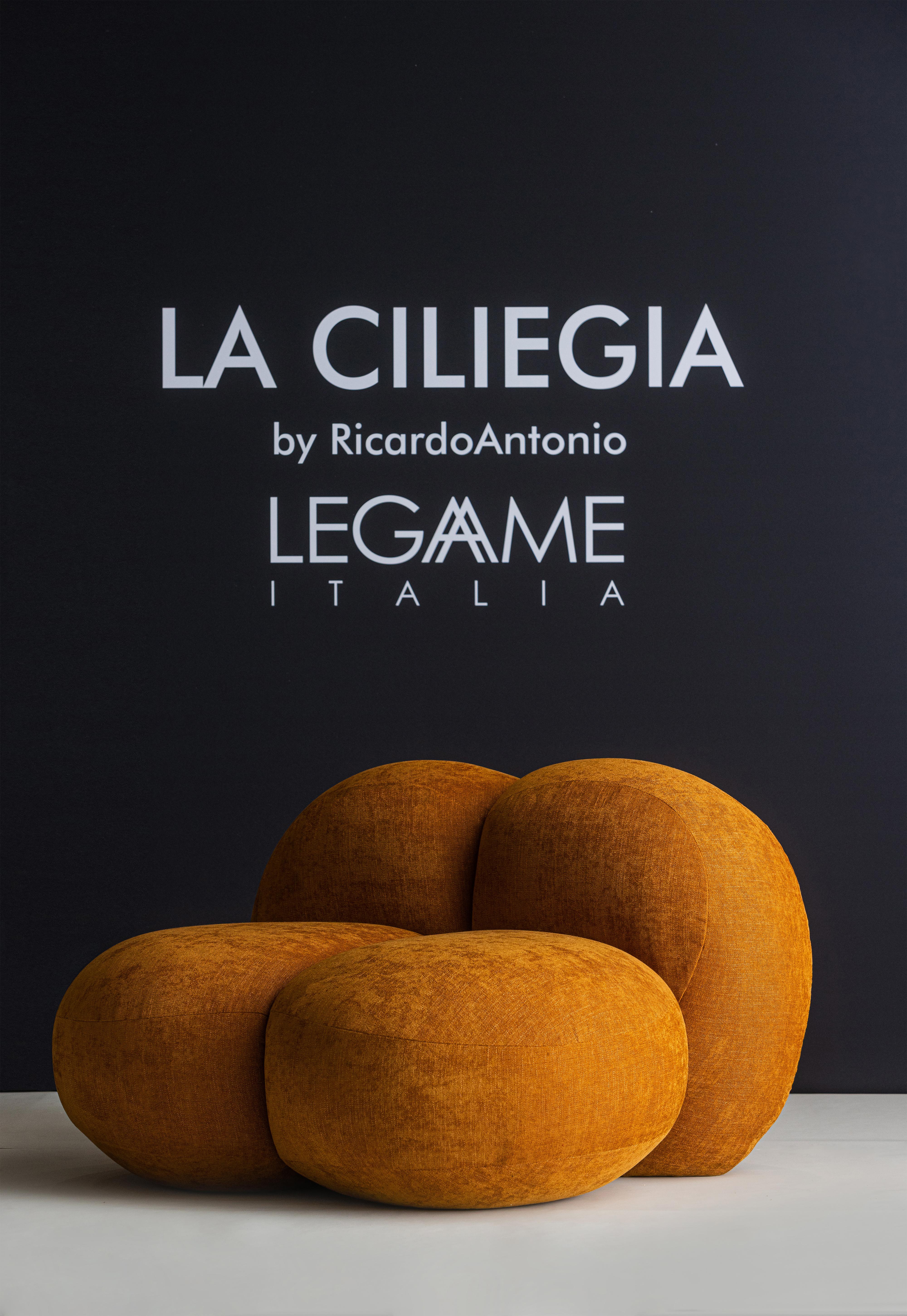 Brazilian designer Ricardo Antonio, famous for his ability to create iconic design pieces, has transformed the organic shapes of a fruit, the cherry, into an armchair, a distinctive object. 
The proportions are abundant and playful, the color