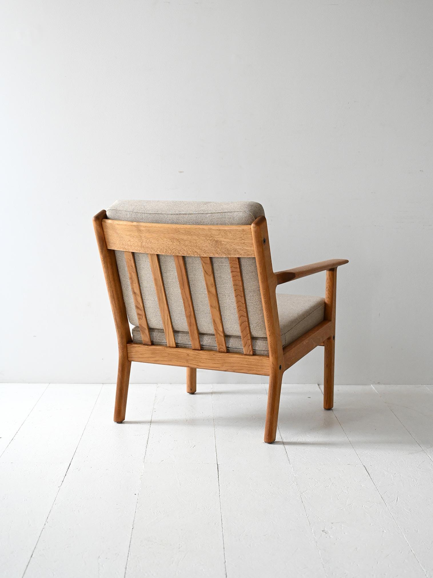 GE265 armchair by Hans J. Wegner for Getama, Denmark. Solid oak, fixed back, original stamp, upholstery and fabric in excellent condition.

Danish armchair model GE265 designed by Hans J. Wegner in 1956 and manufactured by Getama in Denmark. The