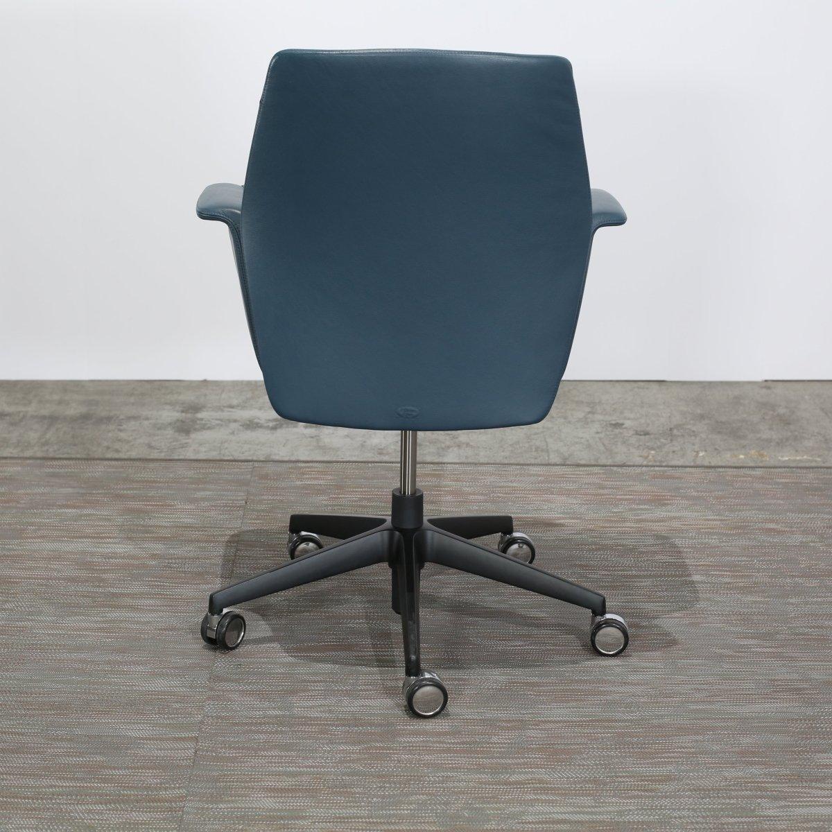 Introducing the epitome of sophistication and elegance - the Downtown Managerial Armchair by Poltrona Frau. This luxurious armchair is crafted with high quality leather, offering unparalleled comfort and style. The sleek and modern design features a