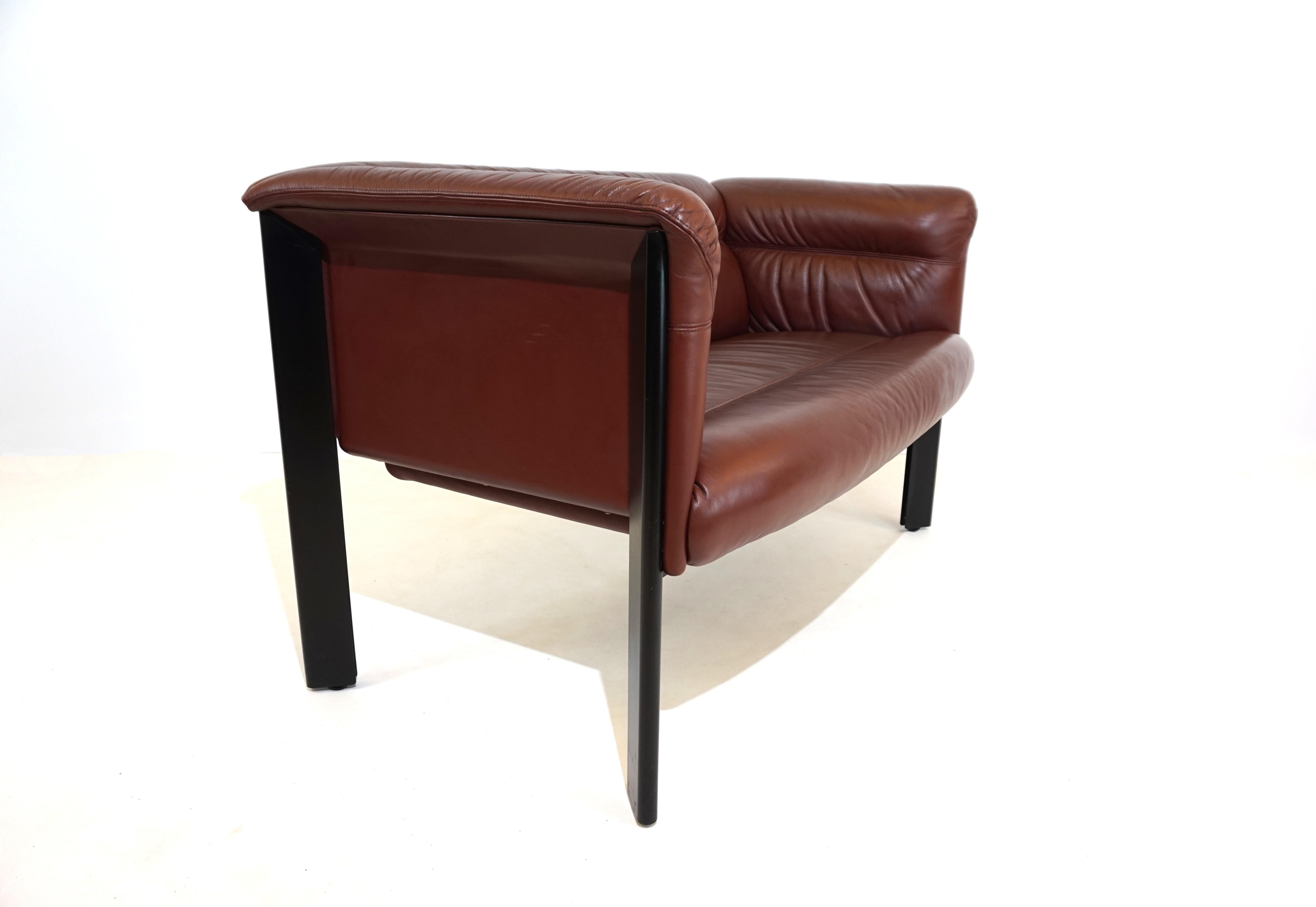 An exceptional Interlude 2 seater by Marco Zanuso for Poltrona Frau in excellent condition. The red-brown, soft leather of the armchairs only shows minimal signs of wear at the corners of the backrests. The leather paneling on the sides is in