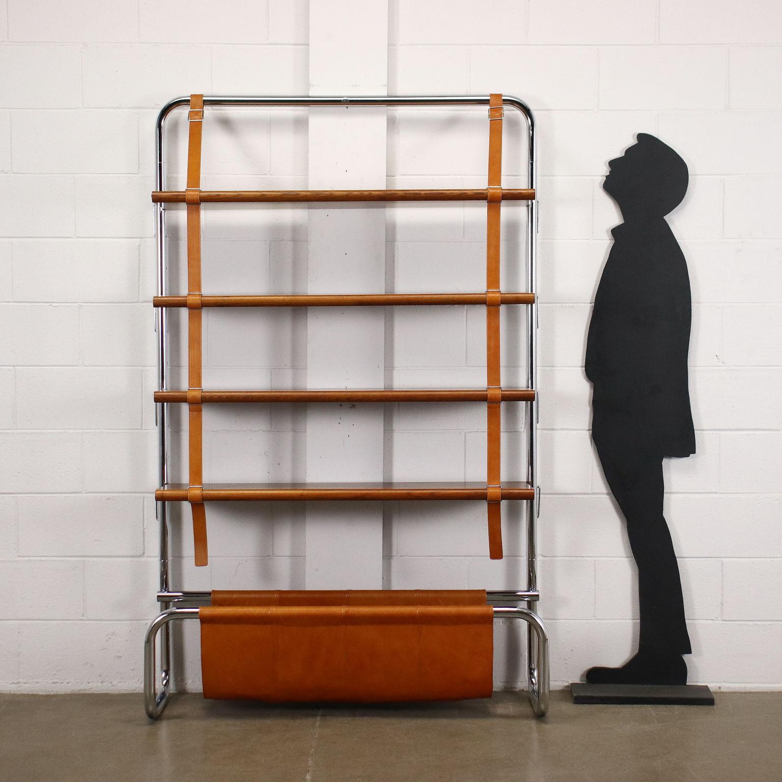 70's wall bookcase with chromed tubular steel structure, shelves in birch wood, belt supports and leather magazine rack. Good conditions.