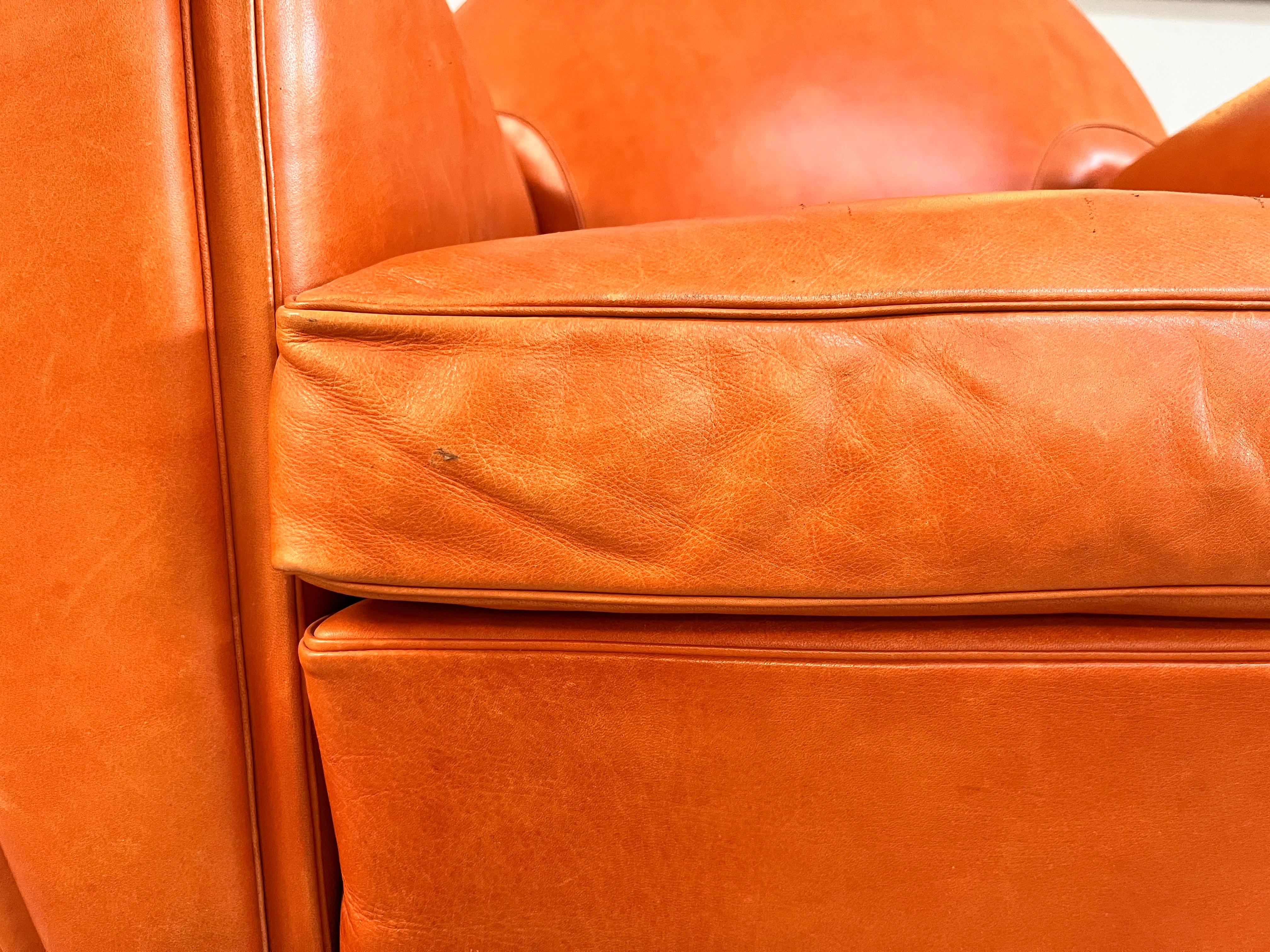 Produced by Poltrona Frau, this armchair is one of the world's best-known design icons: an iconic armchair made in a limited and numbered edition. Upholstered in precious Nubuck leather, finished in shades of orange. The product is embellished with