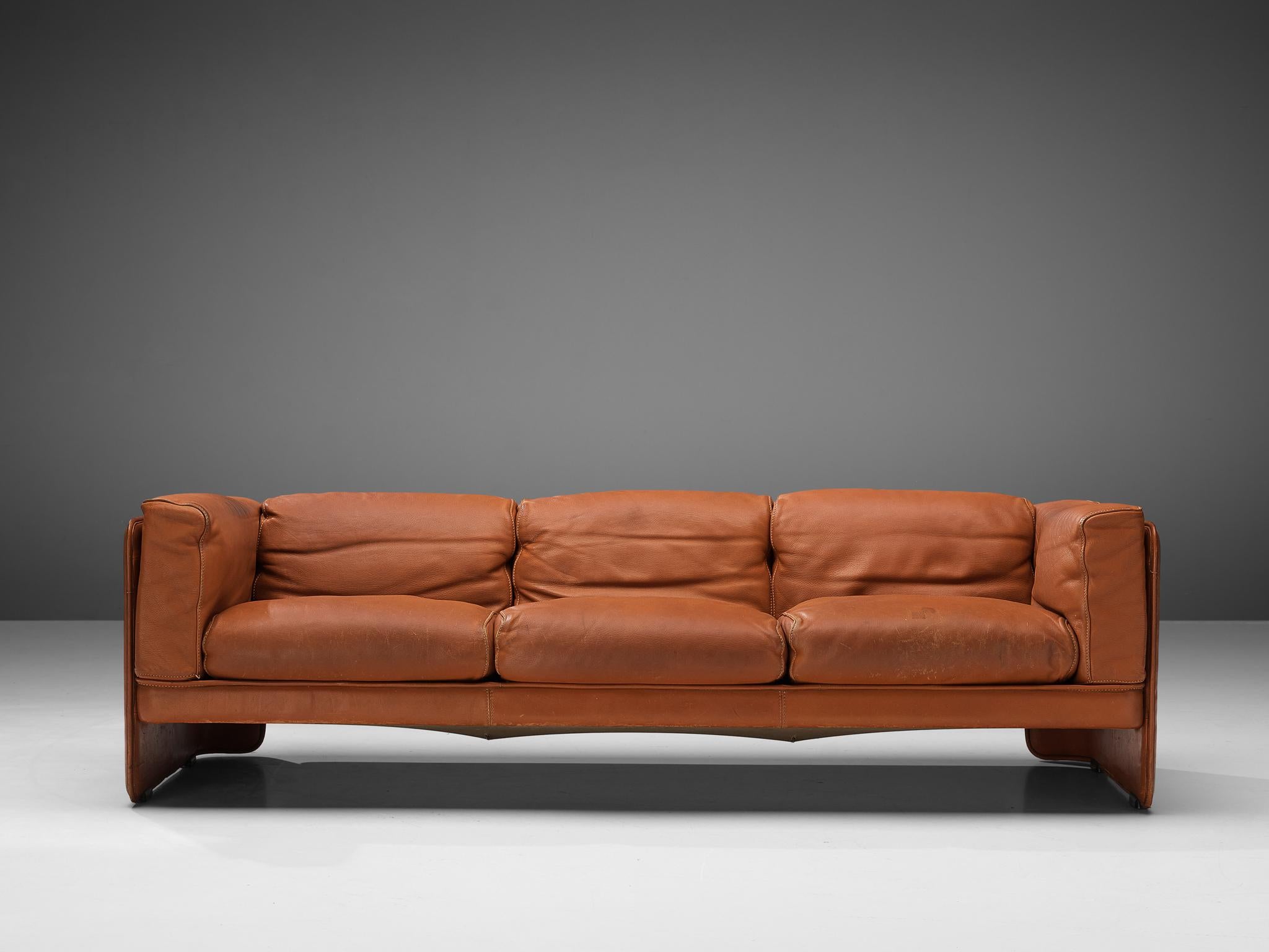 Poltrona Frau, sofa, leather, Italy, 1970s

This striking three-seat sofa is manufactured by Poltrona Frau and fully executed in reddish brown leather that contributes to a monochrome look. The frame holds the seat together and simultaneously