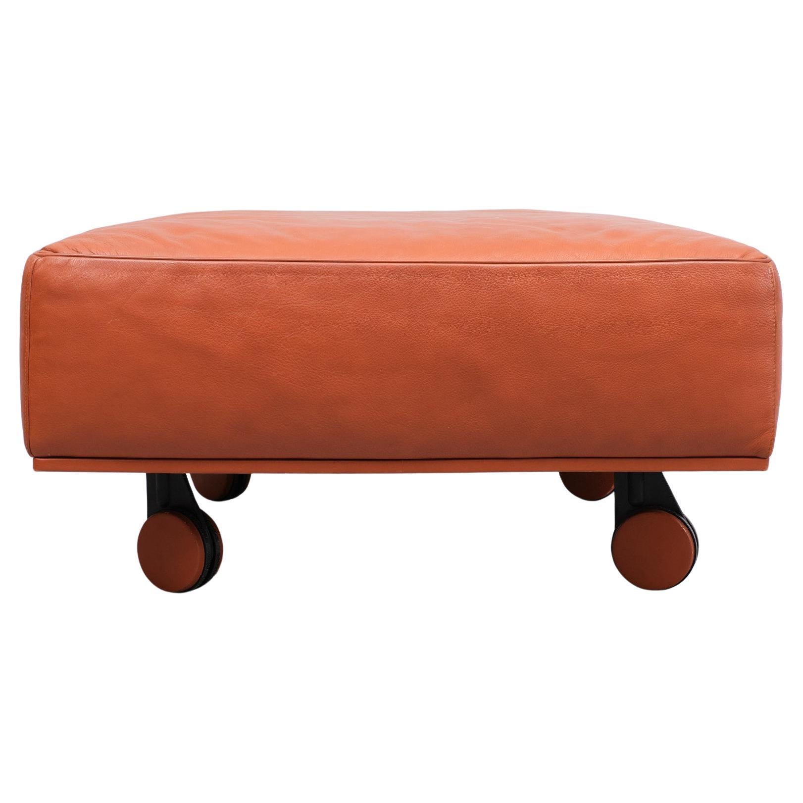 Beautiful top quality Ottoman .on wheels .Original Orange color .Designer Pierluigi Cerri.  Poltrona Frau is widely praised for the phenomenal quality of the leather used in their products. The leather is of such high quality that car brands such as