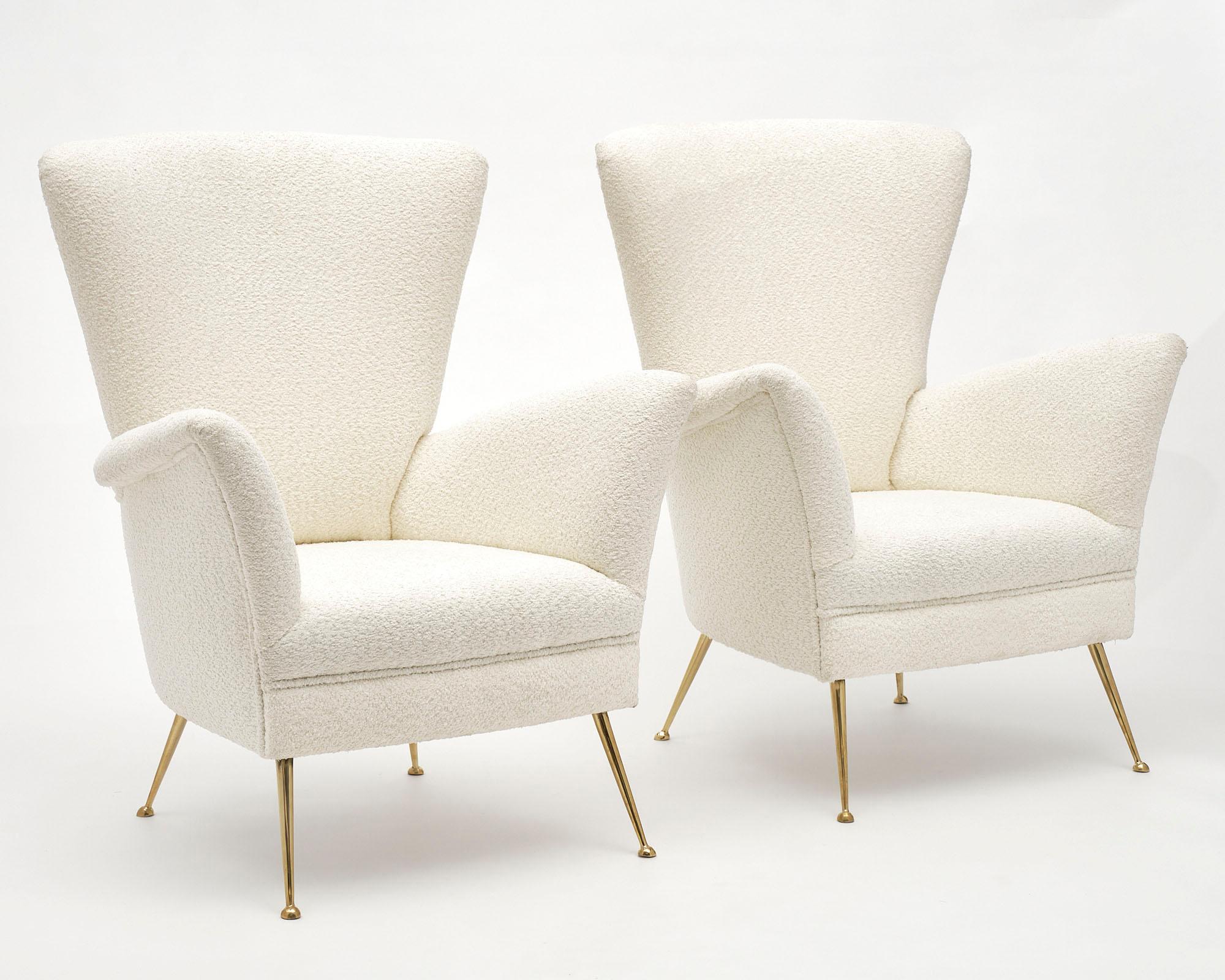 Pair of Italian armchairs by Poltrona Frau. Newly upholstered with “bouclé” with stiletto brass legs.