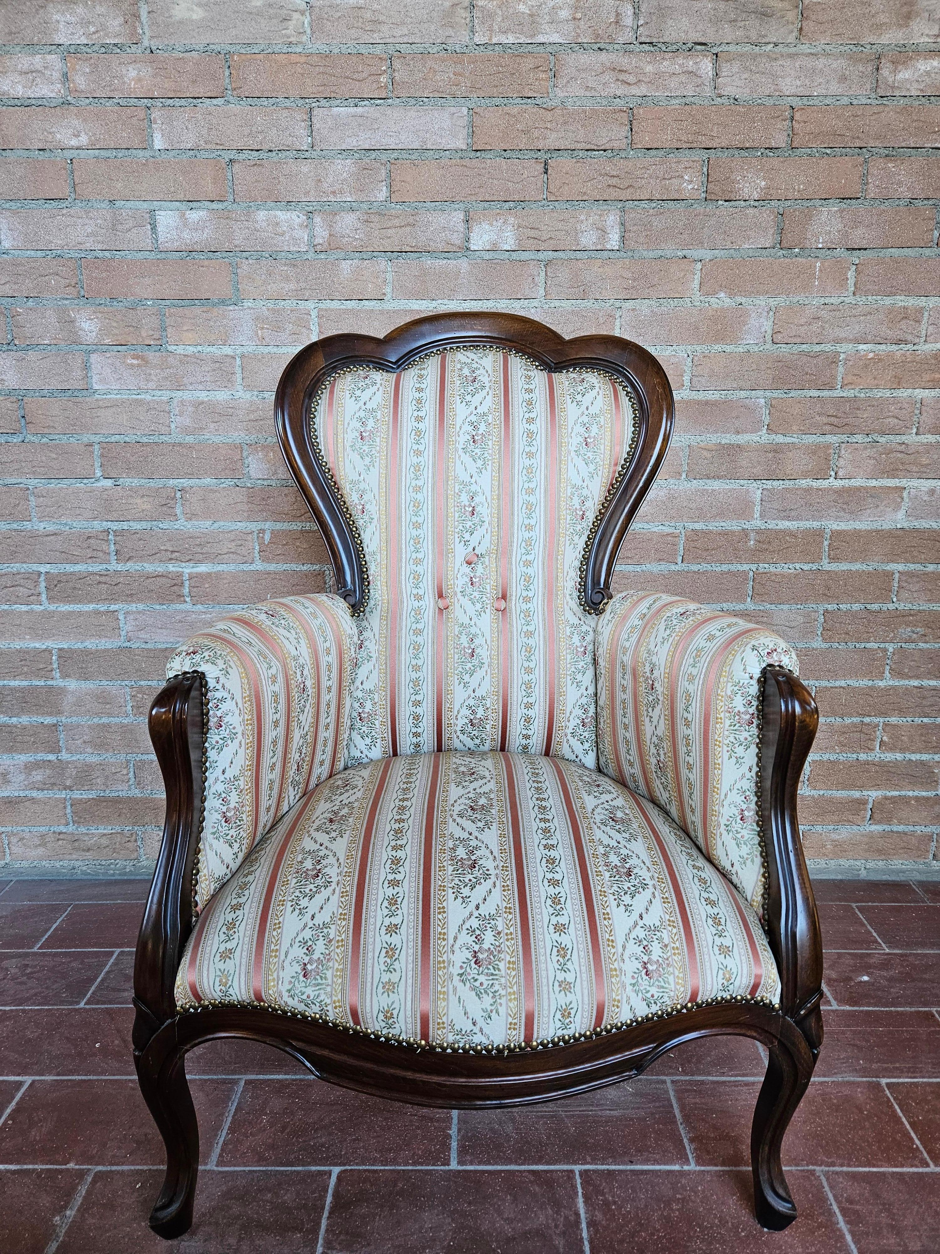 Louis Philippe style upholstered armchair with walnut frame and floral damask fabric.

Normal signs of wear due to age and use.
