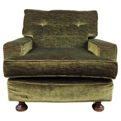 Green fabric armchair with wooden feet