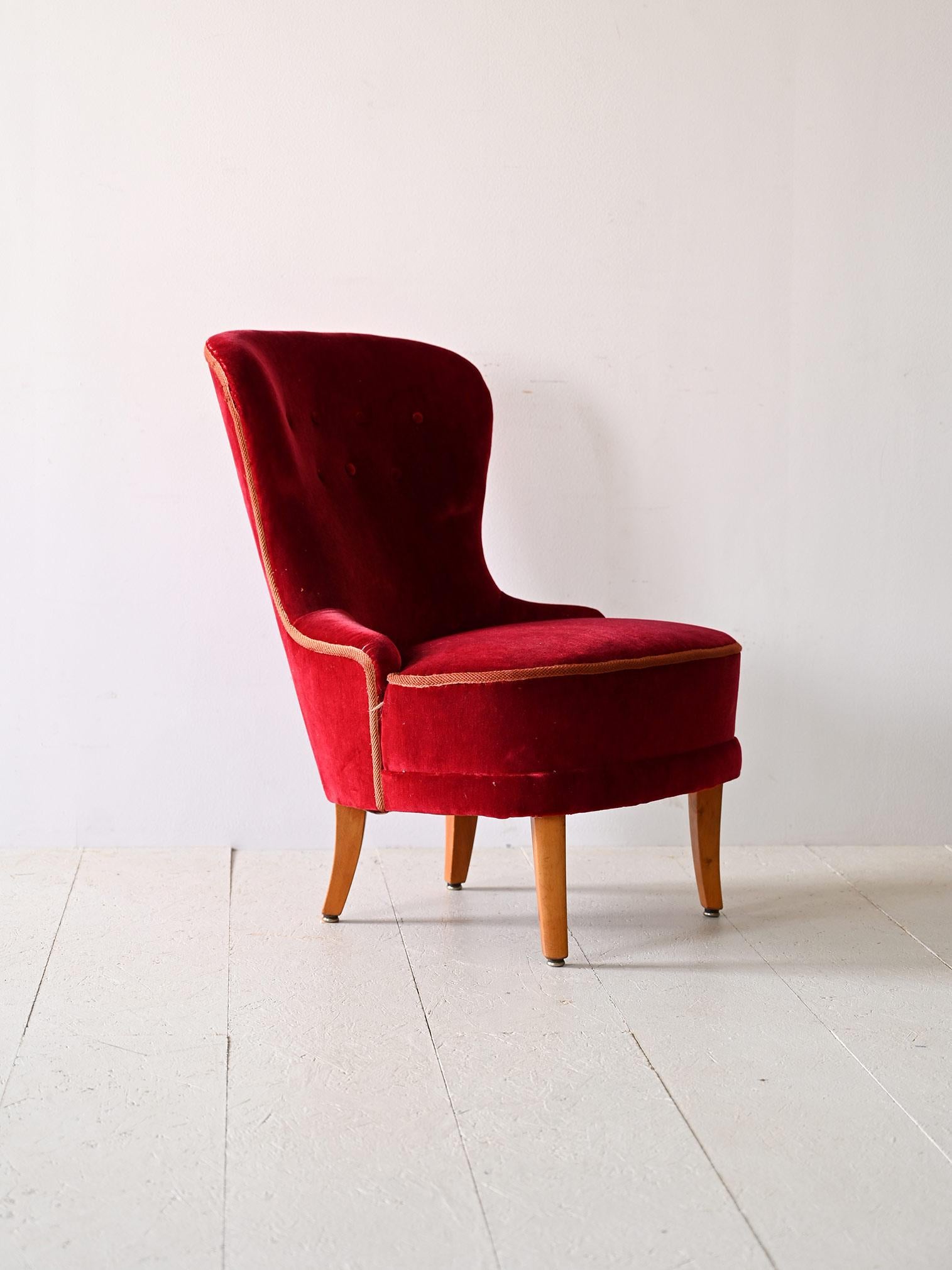 Vintage red velvet armchair.

This red-colored velvet armchair embodies the elegance and sophistication of the Scandinavian style of the 1940s. Its tapered legs add a light, modern touch to the structure, while the slightly curved features give the