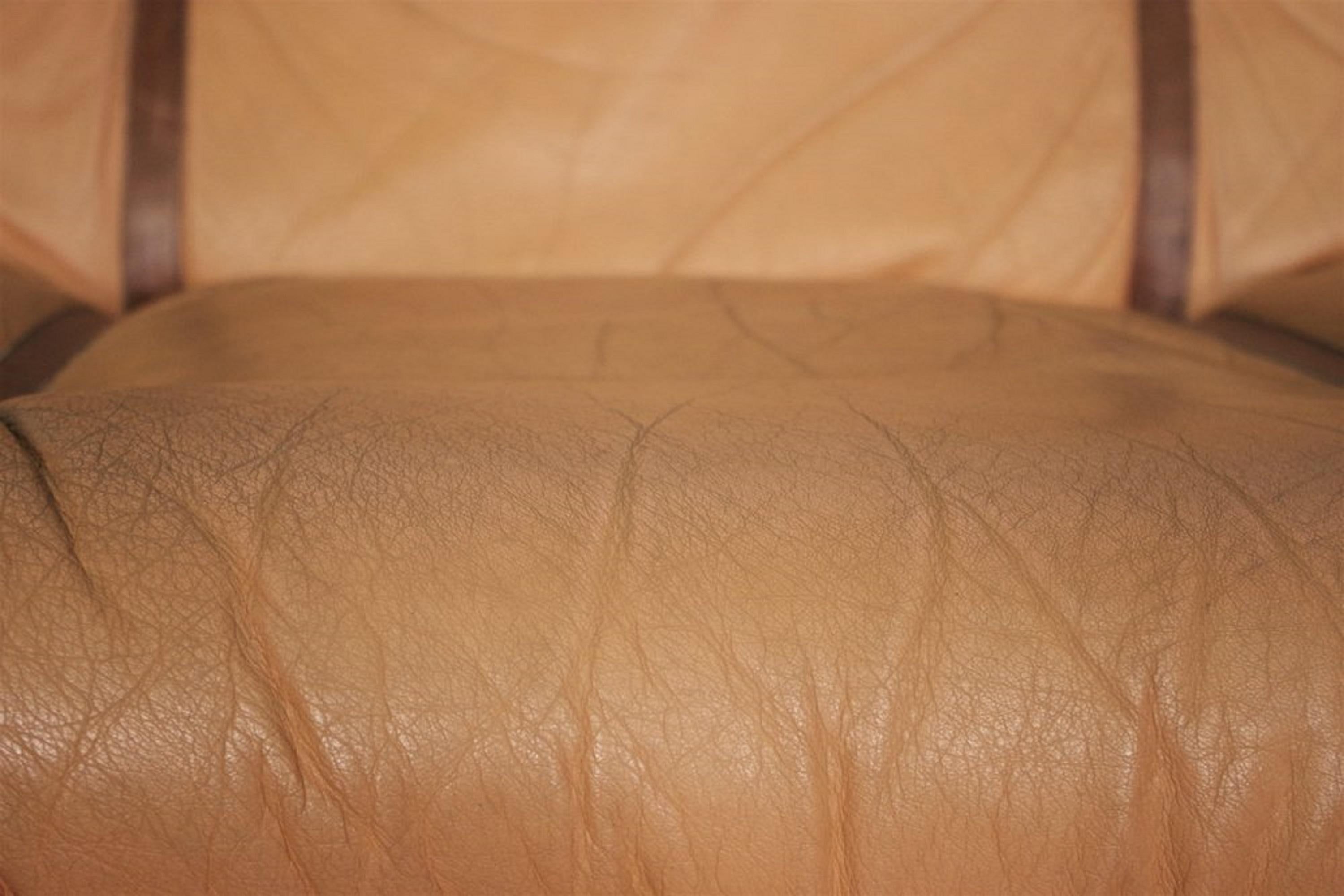 A fine set of 4 original armchairs produced by Lev & Lev in the 1970s, perfectly representative of Italian design of the time. Characterized by a cozy, enveloping silhouette, these seats elegantly combine orange-colored cowhide with a brown fabric