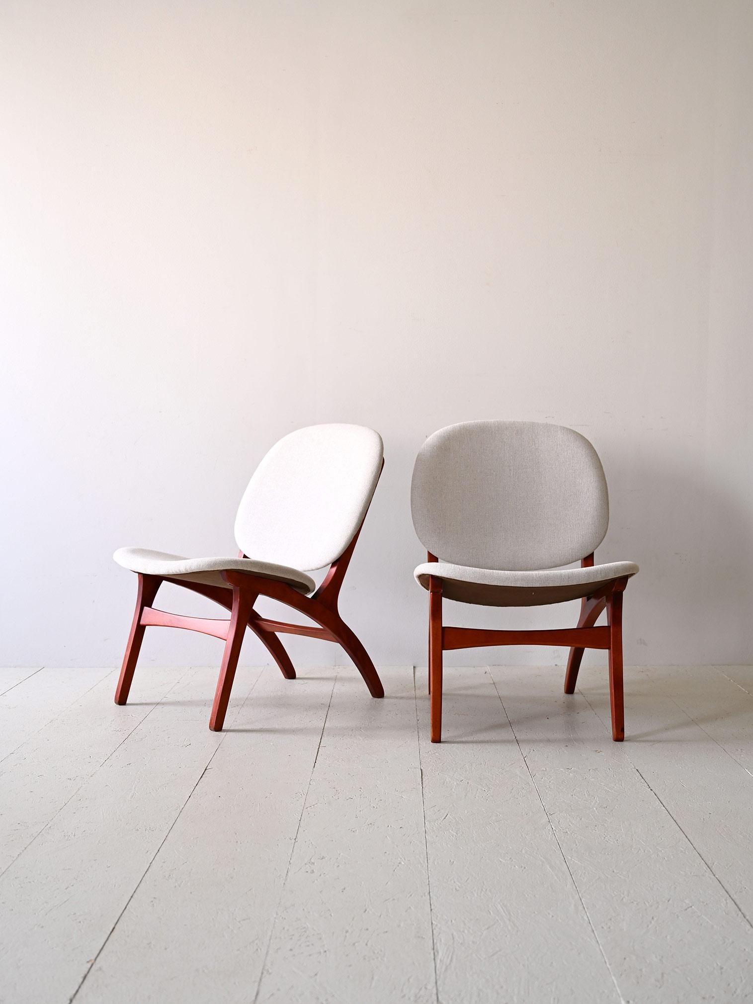 Pair of Nordic armchairs with white fabric  designed by Carl Edward Matthes in the 1950s.

A pair of armchairs expressing timeless elegance, characterized by a refined color scheme. The white fabric of the seating creates an eye-catching contrast