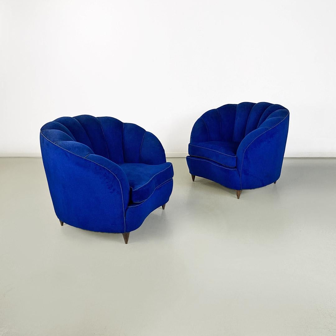 Pair of shell-shaped armchairs in electric blue cotton fabric original to the period, edged with cord and conical wooden legs.
1950 ca.
A third smaller armchair belonging to the same set is available.
Very good condition.
Measurements in cm