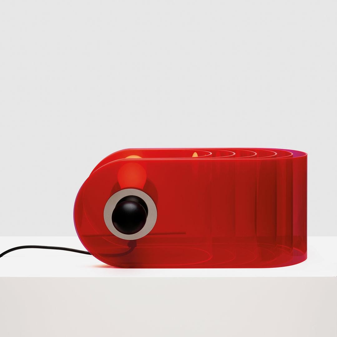 The Gherpe table lamp does not belong to the traditional typologies of lighting fixtures placed on a surface, due to its form like the shell of a marine creature, and to its use of an industrial material like methacrylate. It represents one of the