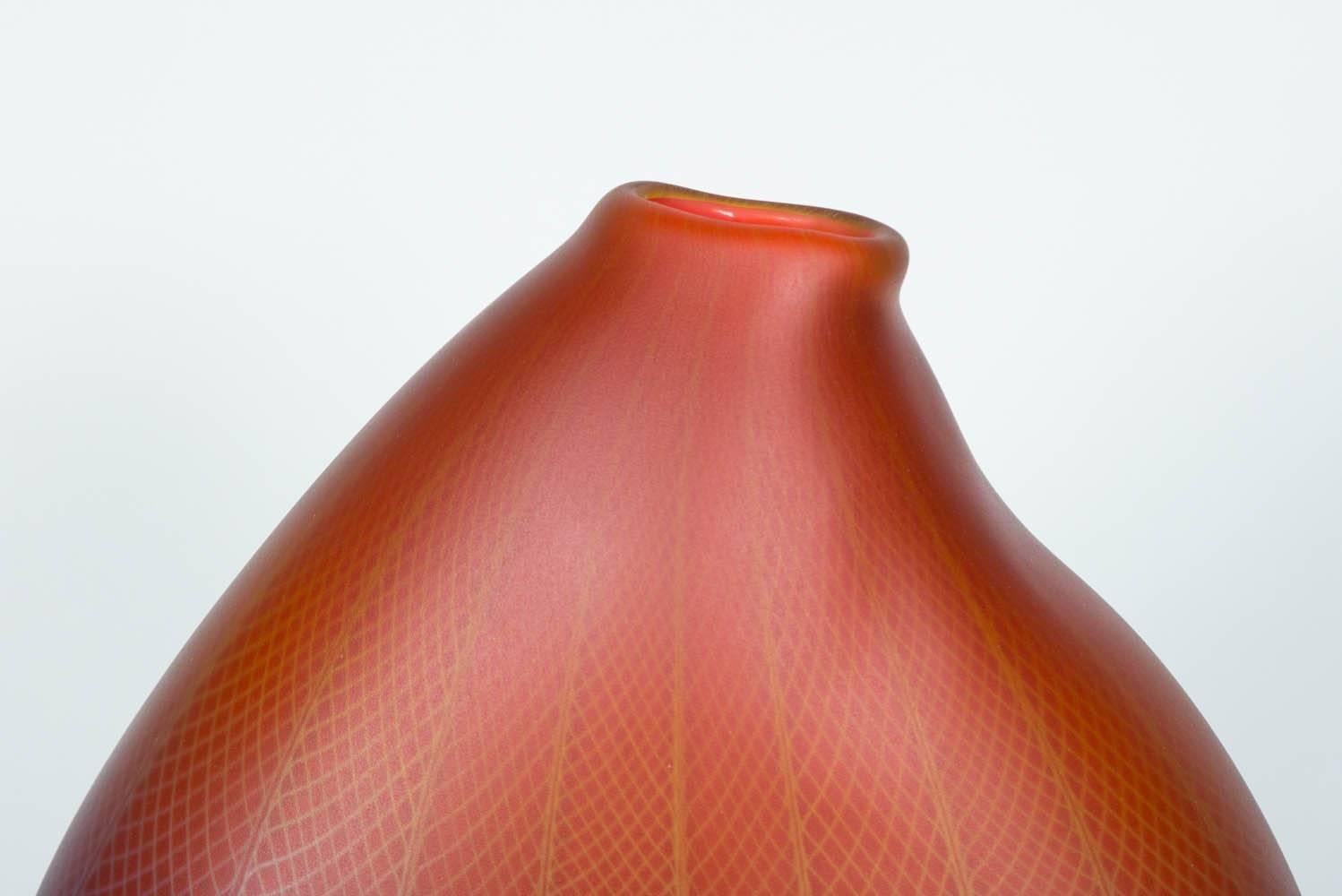 Polychromatic Interleave 005, is a unique handblown glass vessel with fine filigree white cane detail by the British artist Liam Reeves. The two colours of glass in red and blue, merge in the making to create a larger spectrum of hues where they