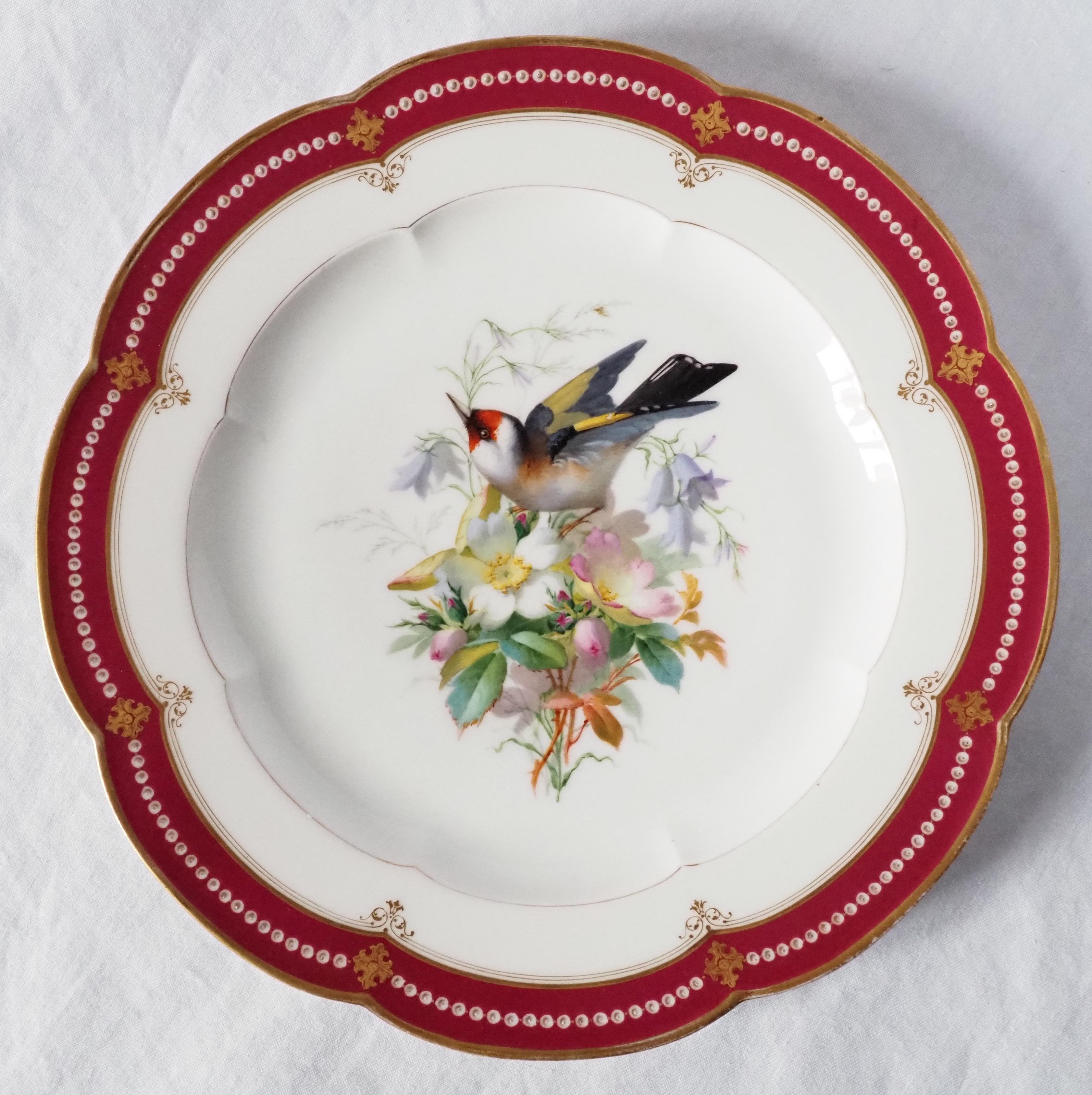 A fine hand painted porcelain plate enhanced with fine gold, Napoléon III period, mid 19th century.
It is decorated with a very finely hand painted bird (a goldfinch) on top of a bouquet of wild roses and campanulas. The edge is burgundy-colored,