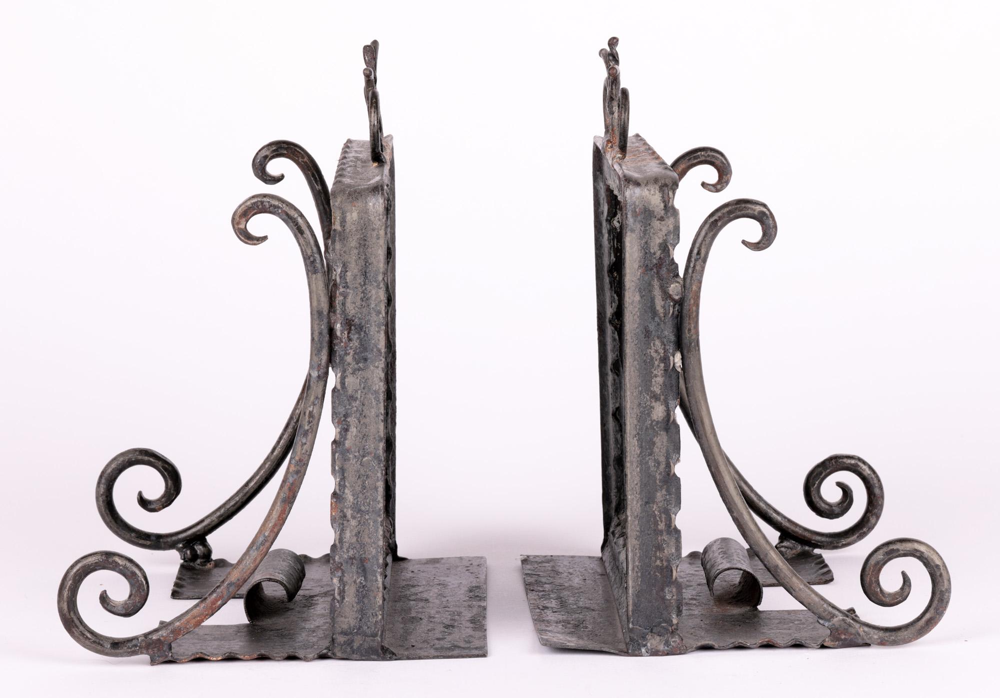 A very unusual pair Arts & Crafts hand-crafted metal framed bookends mounted with 18th century polychrome pottery tiles dating from the 19th century. The bookends are made in a folk art style with pewter coated metal frames with shaped flat bases