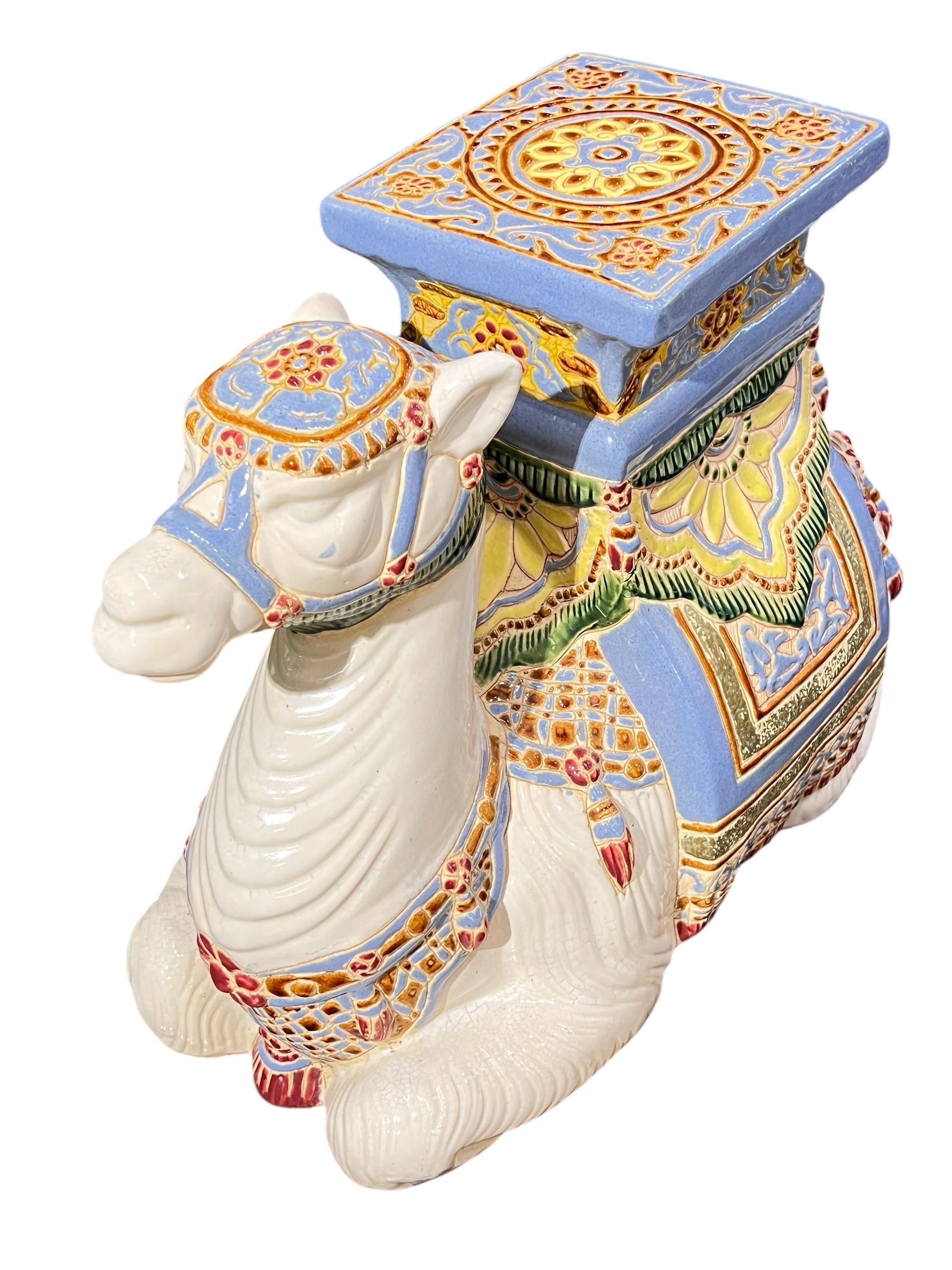 Vintage polychrome glazed seated ceremonial processional Indian camel 
sculpture may also be enjoyed as a plant stand or garden seat. 