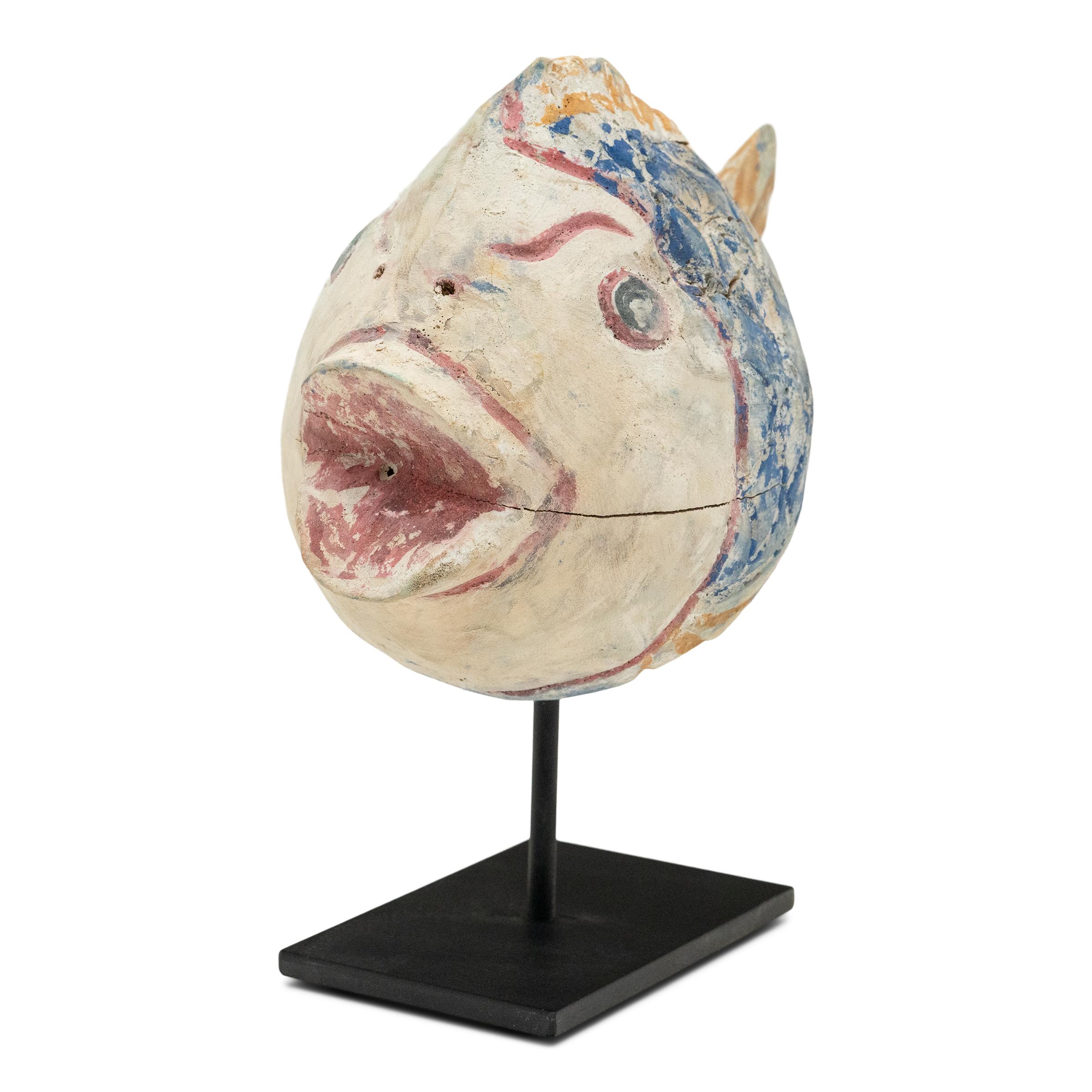 Dieser farbenfrohe Koi-Fisch, der von Hand aus aufgearbeitetem Holz geschnitzt wurde, ist ein traditionelles Symbol für Harmonie, Wohlstand und Glück. Der rustikale Fisch ist mit einem gedrungenen, abgerundeten Körper geschnitzt, die Schuppen und