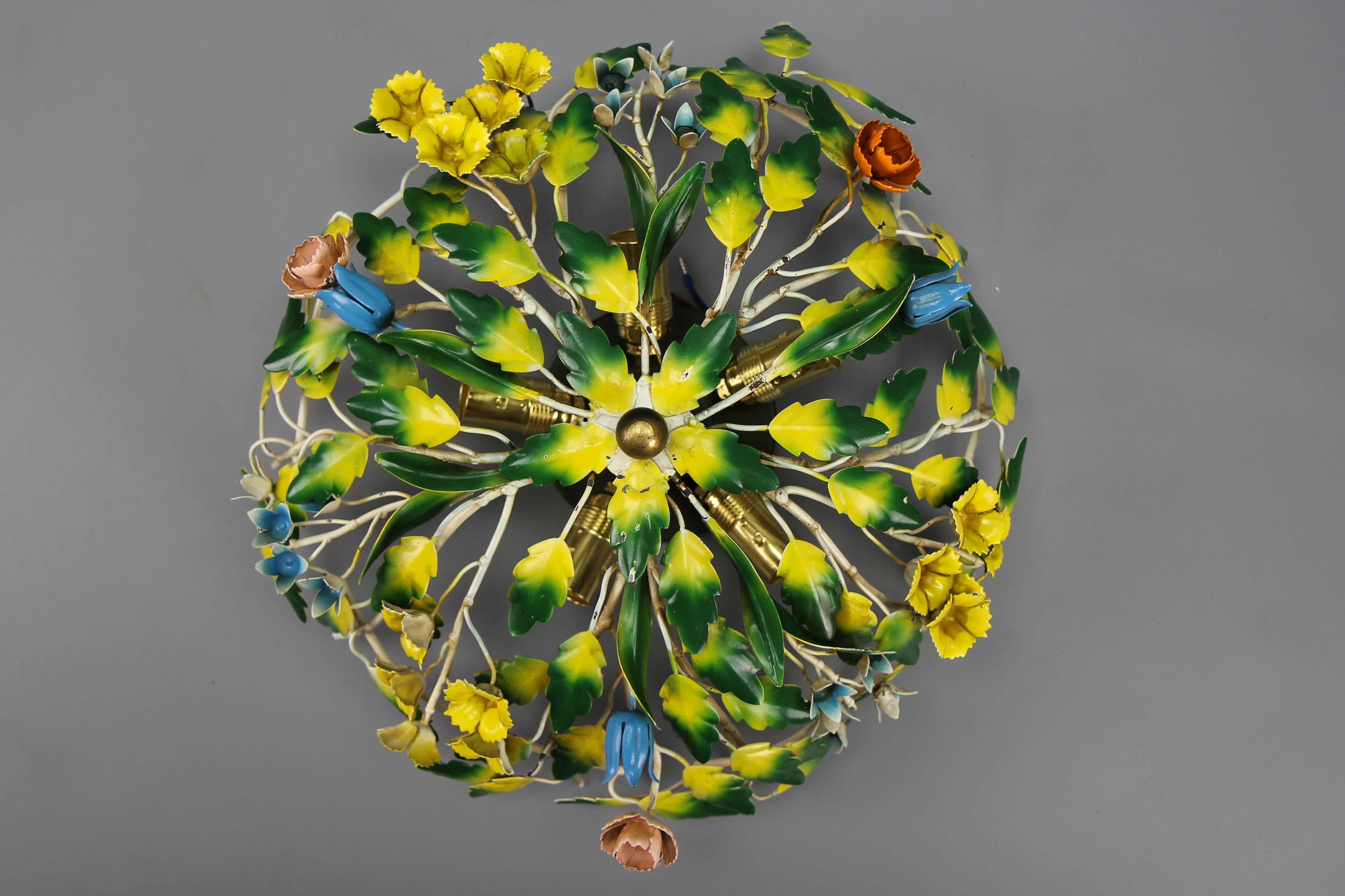 Polychrome painted metal flower five-light ceiling light, Italy, circa the 1970s.
A beautiful Italian ceiling light made of metal with flowers and leaves painted in pastel pink, blue, green, and yellow colors. Five sockets for E-14 size light