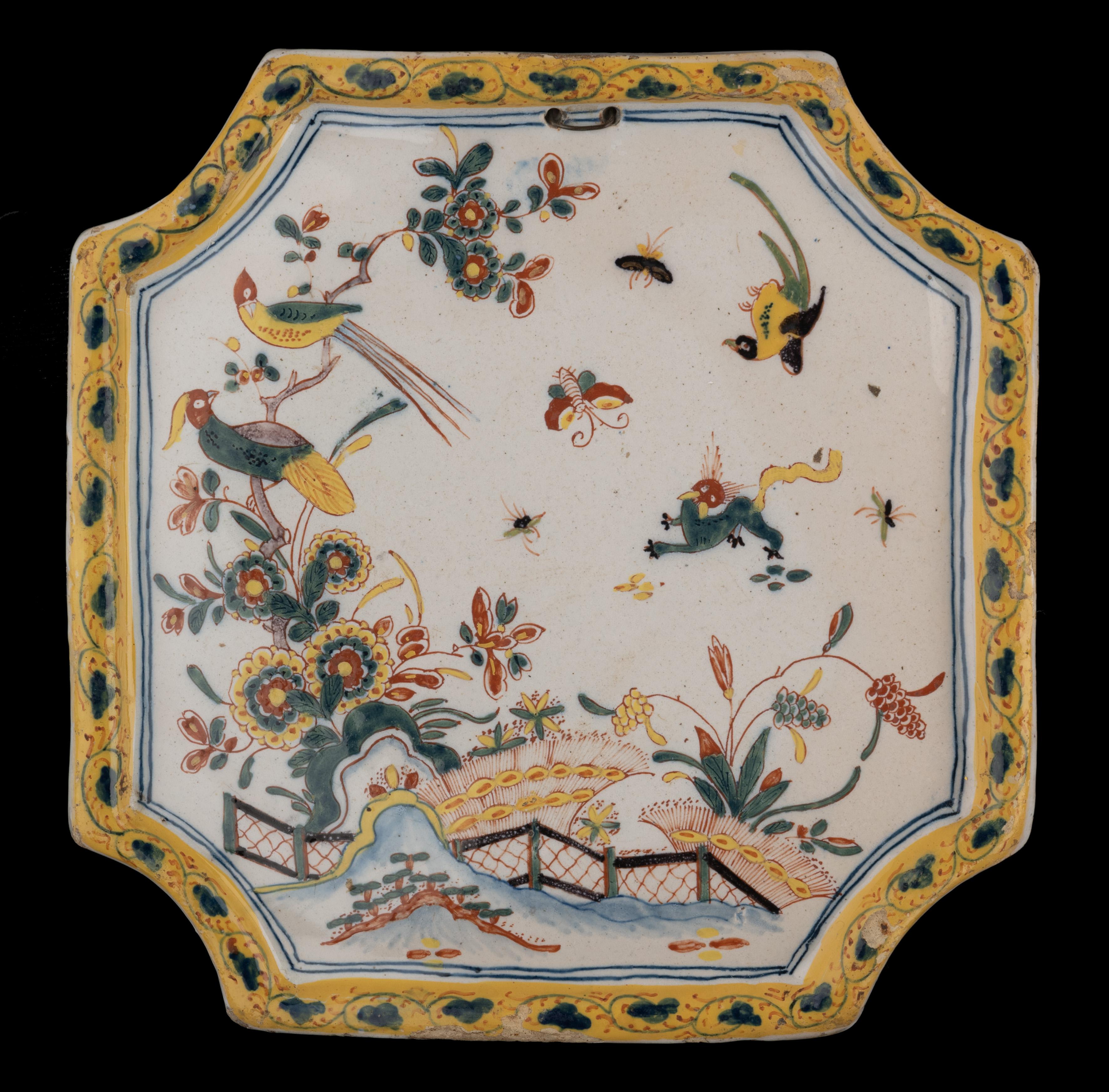 Polychrome plaque with oriental floral decoration Delft, 1740-1760

The square, convex plaque has indented corners and a raised rim and is painted in polychrome with an oriental floral landscape. A fence is set on a rocky ground with vegetation. On