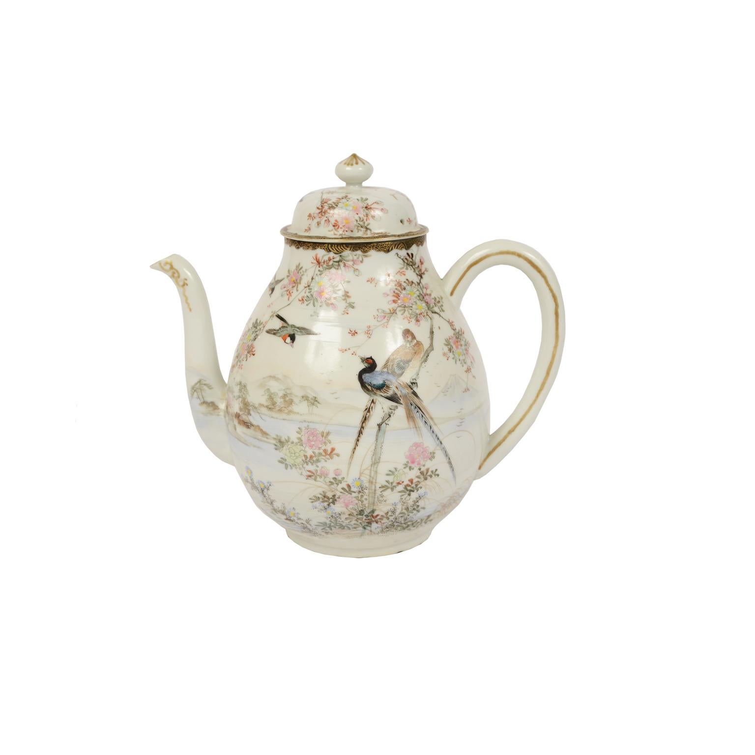 Polychrome hand-decorated porcelain teapot, milk jug and sugar bowl with refined depictions of birds, flowers, and bucolic Japanese landscapes. Good condition, slight chipping in the pouring spout of the teapot, small crack on the handle of the milk
