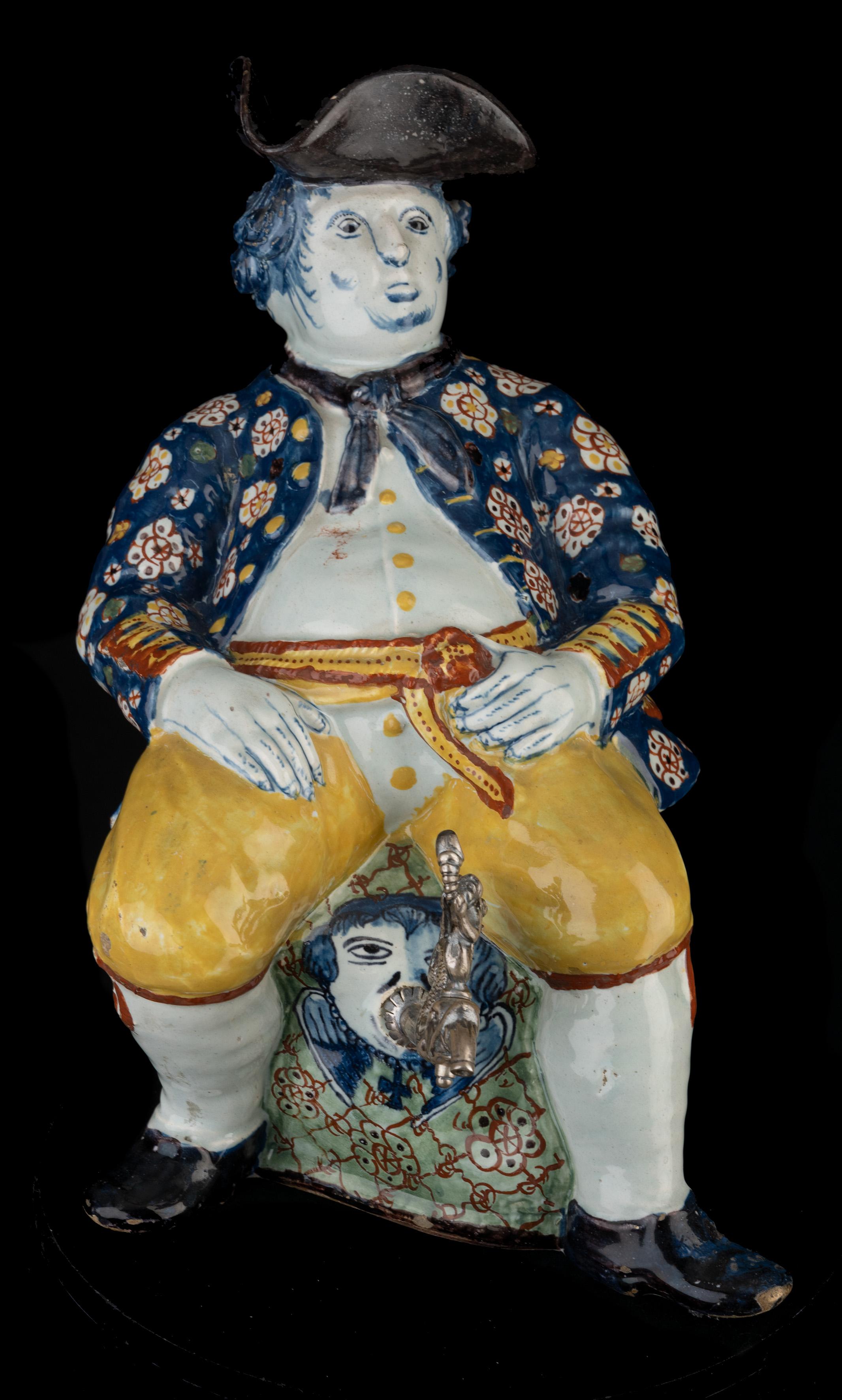 Polychrome table fountain Delft, 1750-1770

The polychrome table fountain is modelled in the form of a corpulent, seated man on a pedestal. He sits leisurely leaning back on a green pedestal with net decor with flowers. He is dressed in a blue