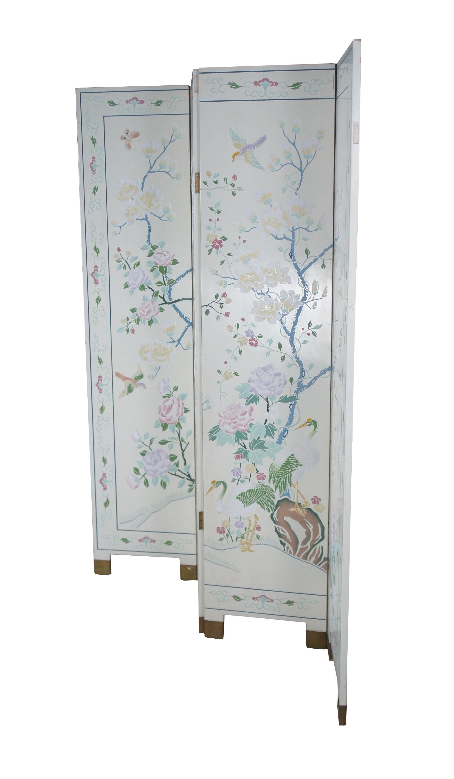 Vintage Hong Kong Chinoiserie room divider or folding screen featuring a white lacquer ground with a landscape screen of birds / cranes / butterflies amongst the flowering Magnolia tree of life. Each double sided panel is affixed with a rotating