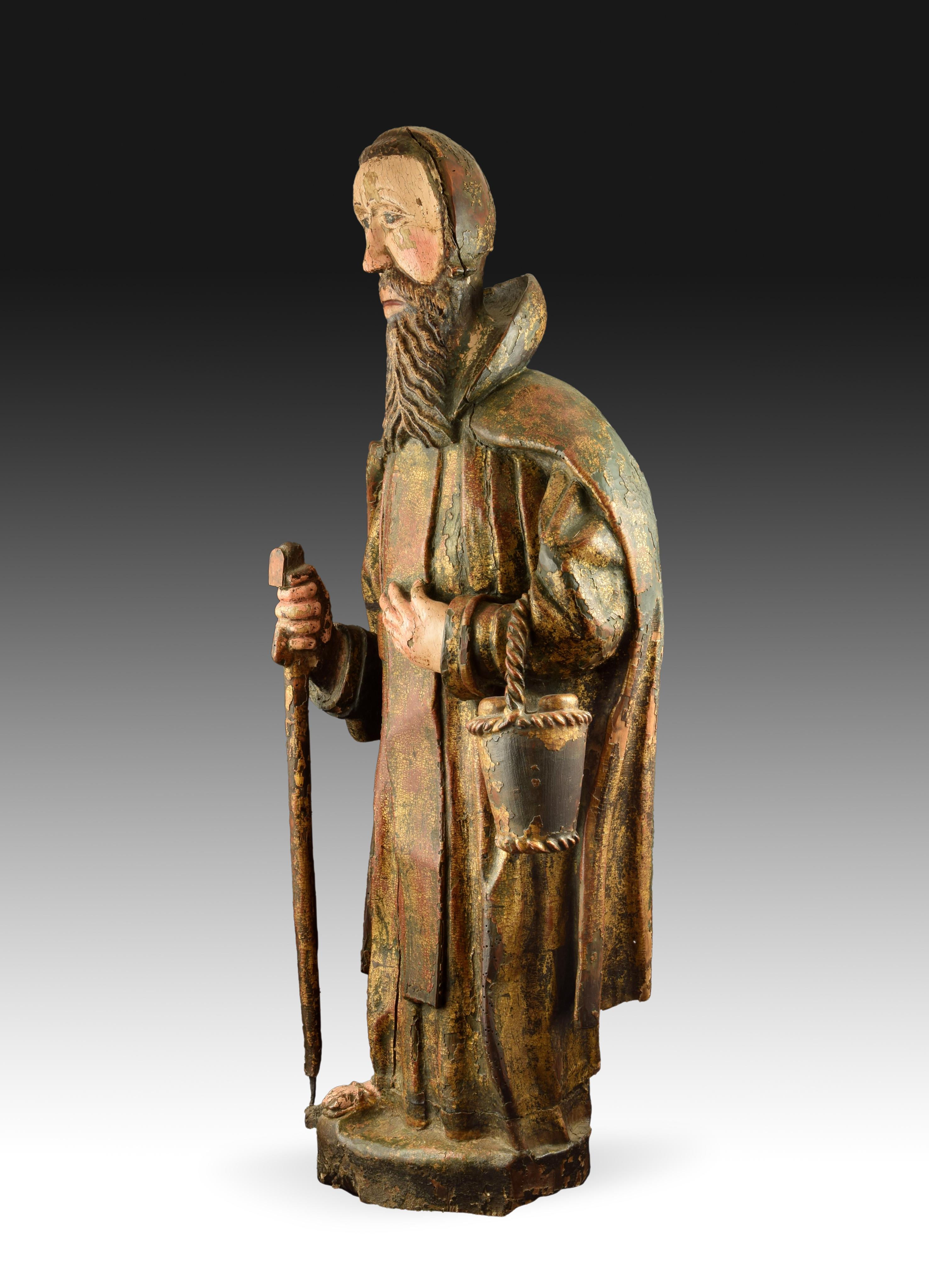 Polychrome wooden sculpture possibly Saint Fiacre. Century XVI. 
Polychrome wood carving of a bearded saint standing on a simple pedestal. They are shown staring straight ahead, holding one hand to their chest and carrying a basket in this, the