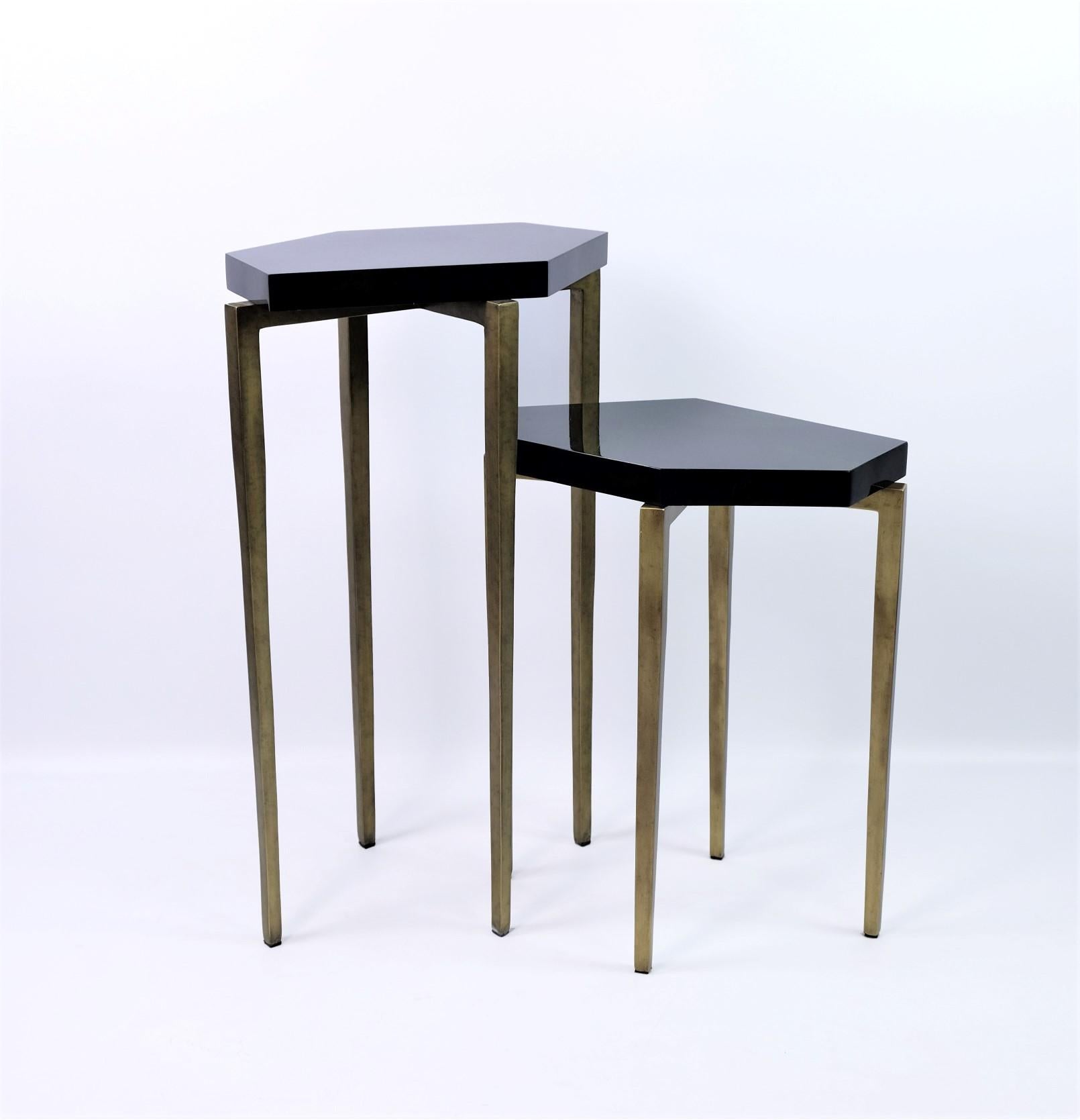 These futurist nesting tables are made of polished green shell marquetry.

They have a polygonal shape top and the metal feet have an antique brass patina.

The tables are small and very versatile. These can be placed anywhere near a sofa and