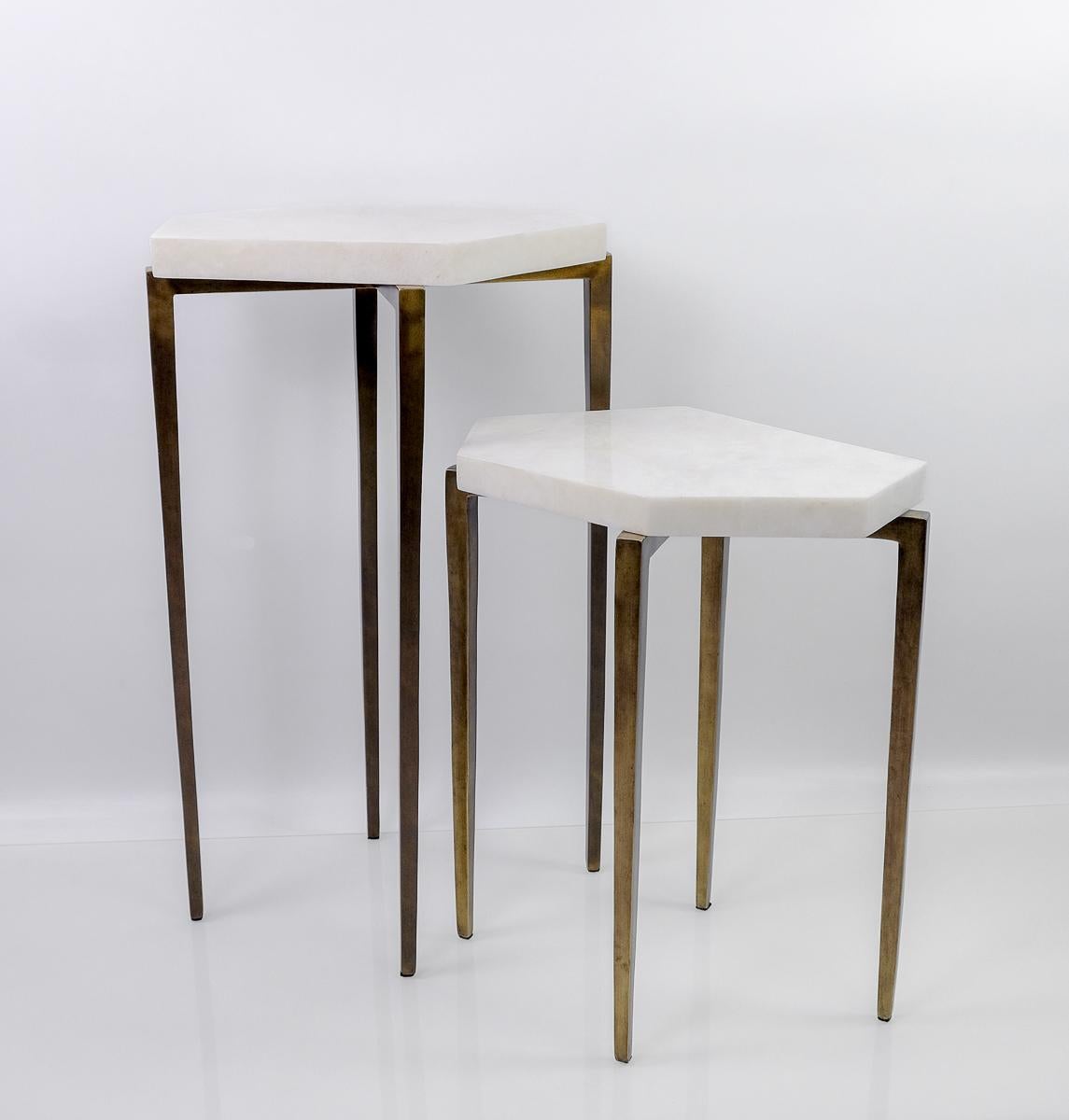 These futurist nesting tables are made of white rock crystal marquetry.

They have a polygonal shape top and the metal feet have an antique brass patina.

The tables are small and very versatile. These can be placed anywhere near a sofa and