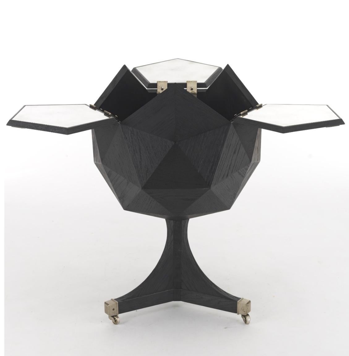 Polyhedron bar cart in the style of Ico Parisi was originally marketed by Restoration Hardware. Beautifully grained oak is wire brushed, to reveal the grain pattern, then lacquered in matte black. The three top panels open, via the nickeled brass