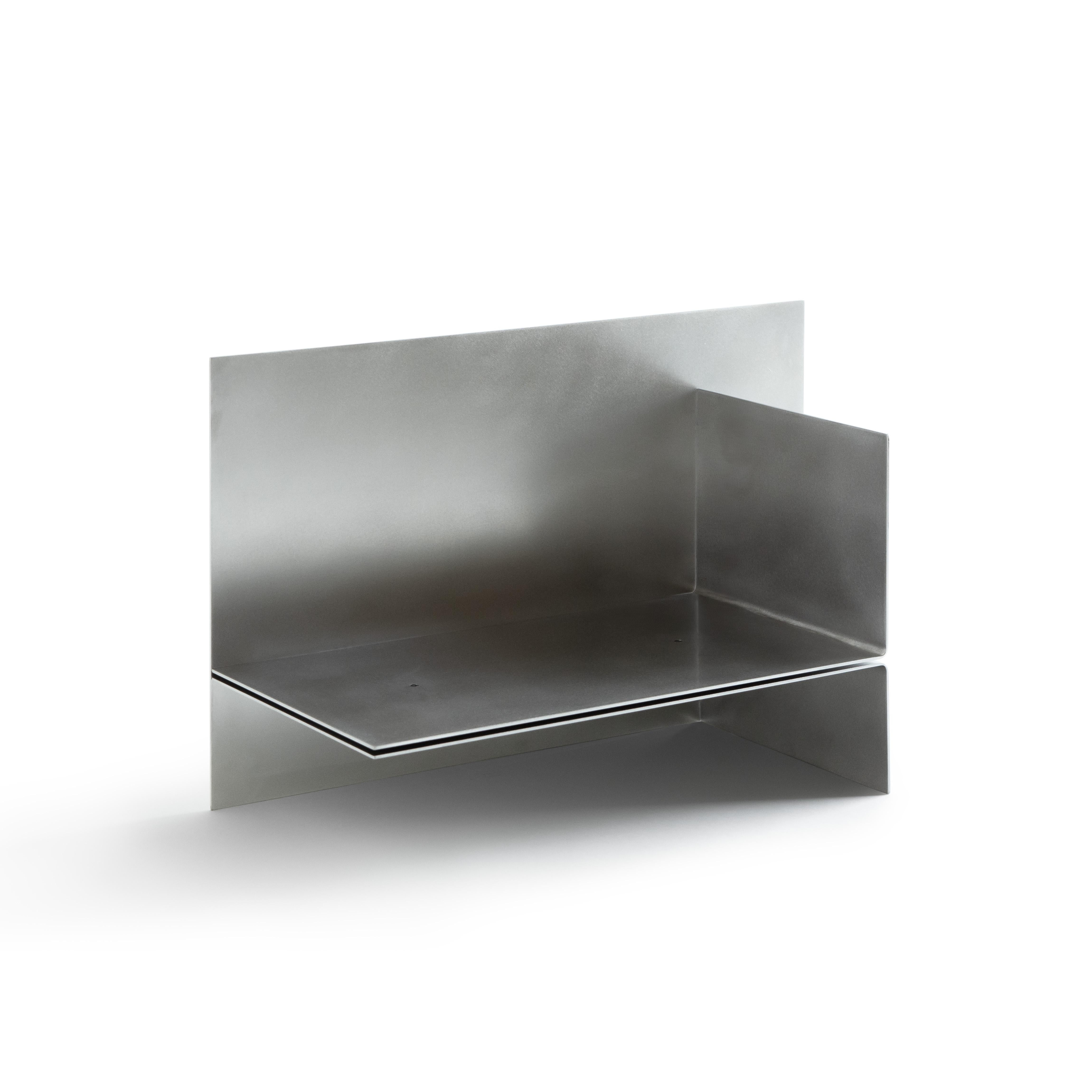 Polysemy_Silver by So Koizumi
Dimensions: W 56.5 x D 25 x H 35 cm
Materials: Stainless steel.
Weight: 11 Kg. 

“Polysemy”, an object that can be placed in different ways from one shape to combine various functions such as a book-shelf or side table.