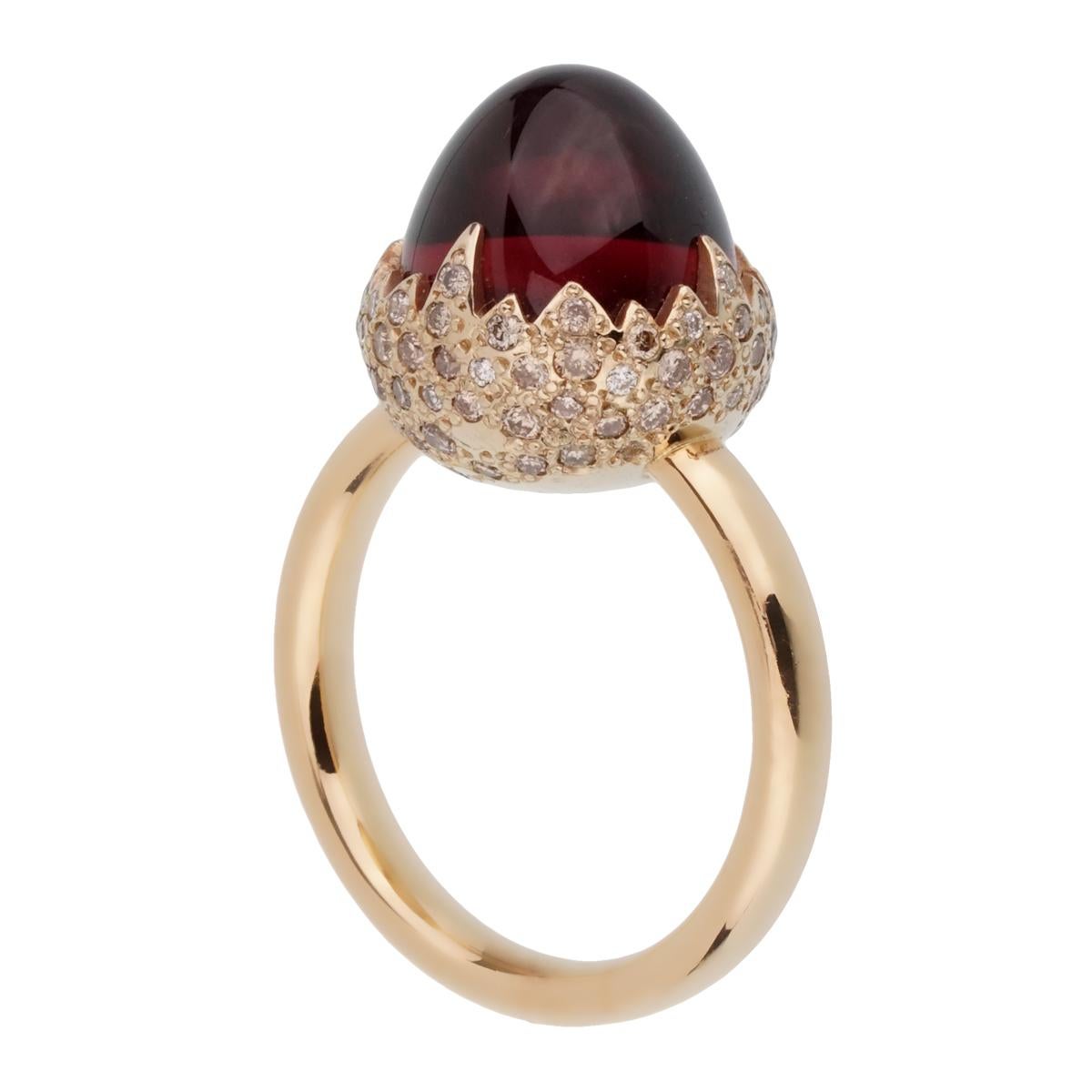 An iconic Pomellato diamond ring showcasing a 6.19ct Garnet encased by .59ct of round brilliant cut diamonds in shimmering 18k gold. The ring measures a size 6 and can be resized

Pomellato Retail: $9450
