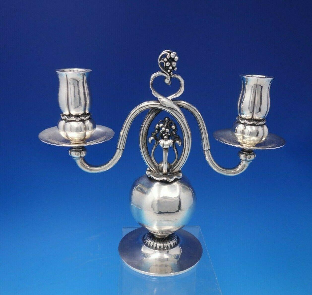 Georg Jensen sterling silver pair of Candelabra, No. 244

Pomegranate by Georg Jensen

Magnificent rare hand hammered Pomegranate by Georg Jensen sterling silver two-light candelabra pair with figural grape design, marked #324. The pieces
