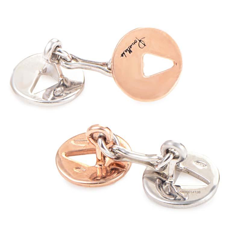 These Pomellato cufflinks are unique and stylish. They are made of 10K rose gold and silver and feature a triangle cutout.
