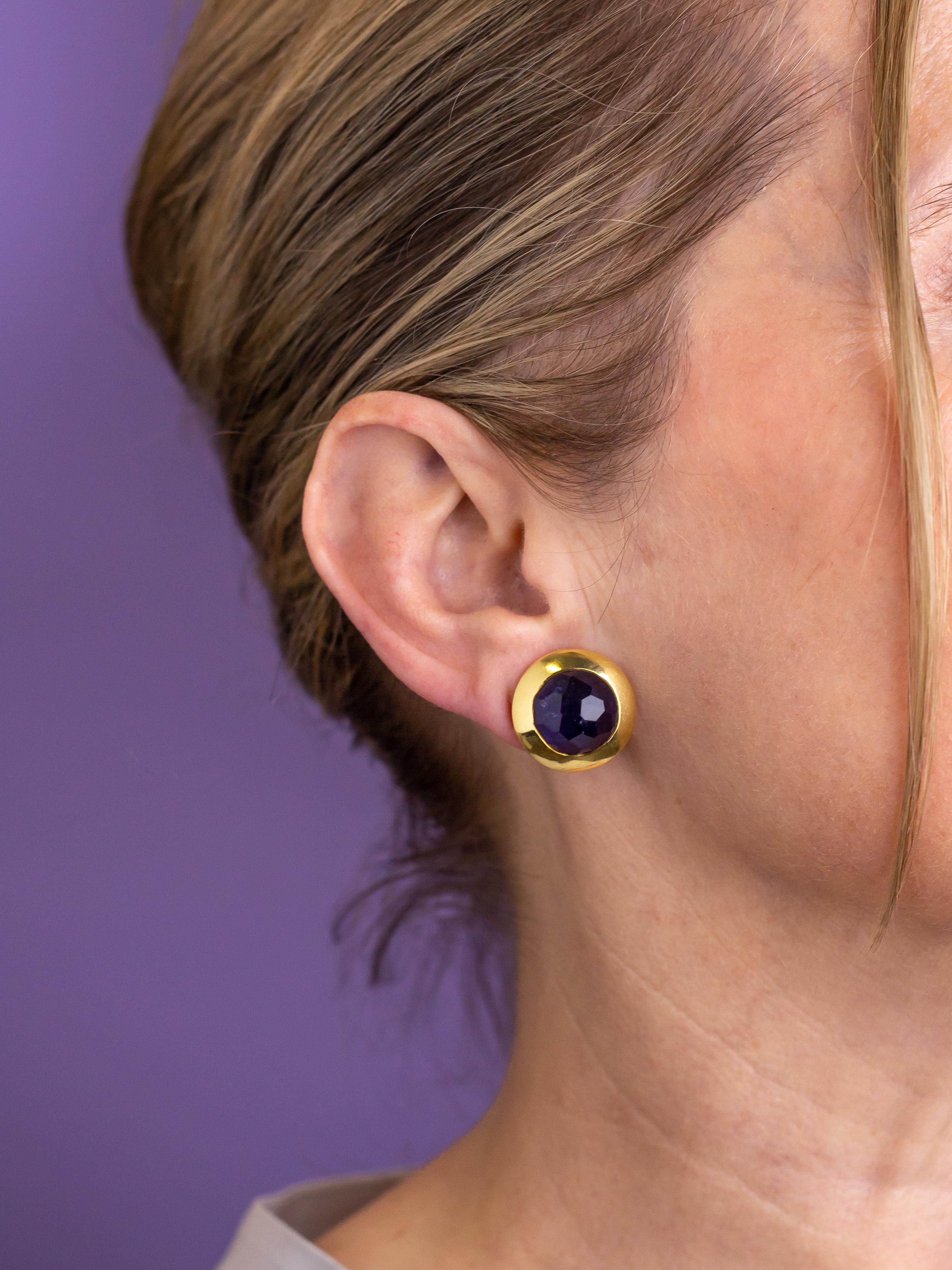 This pair of gold and iolite ear clips were made by the Italian jeweller 'Pomellato'. The brand was established in Milano in 1967 and therefore the earrings can be dated to being manufactured during the last quarter of the 20th Century, or early