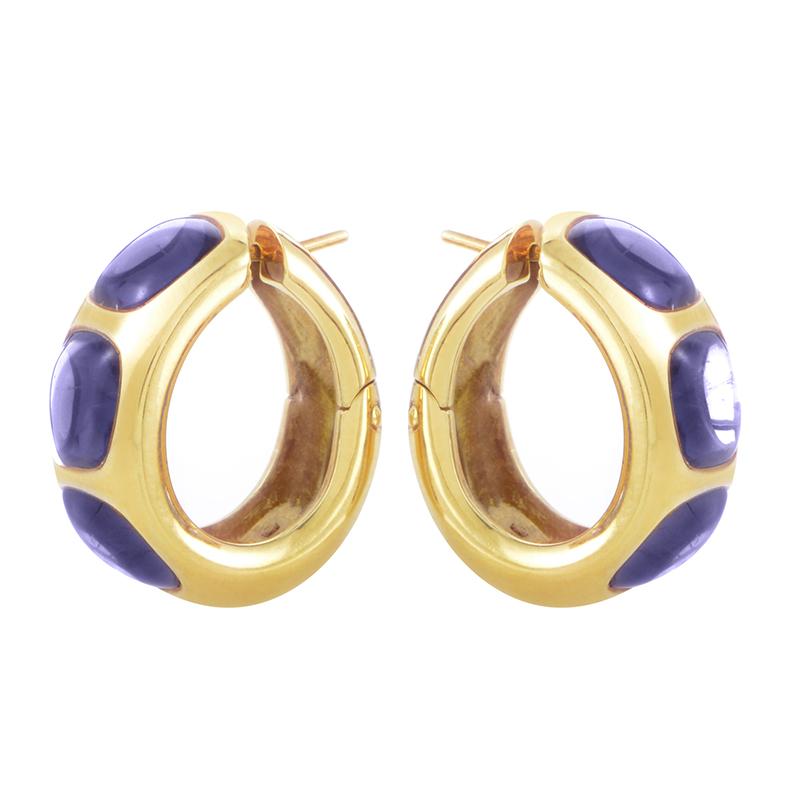 An extraordinary pair of Pomellato earrings made of esteemed 18K yellow gold, spectacularly embellished with attractive iolite stones in delightful purple tone.