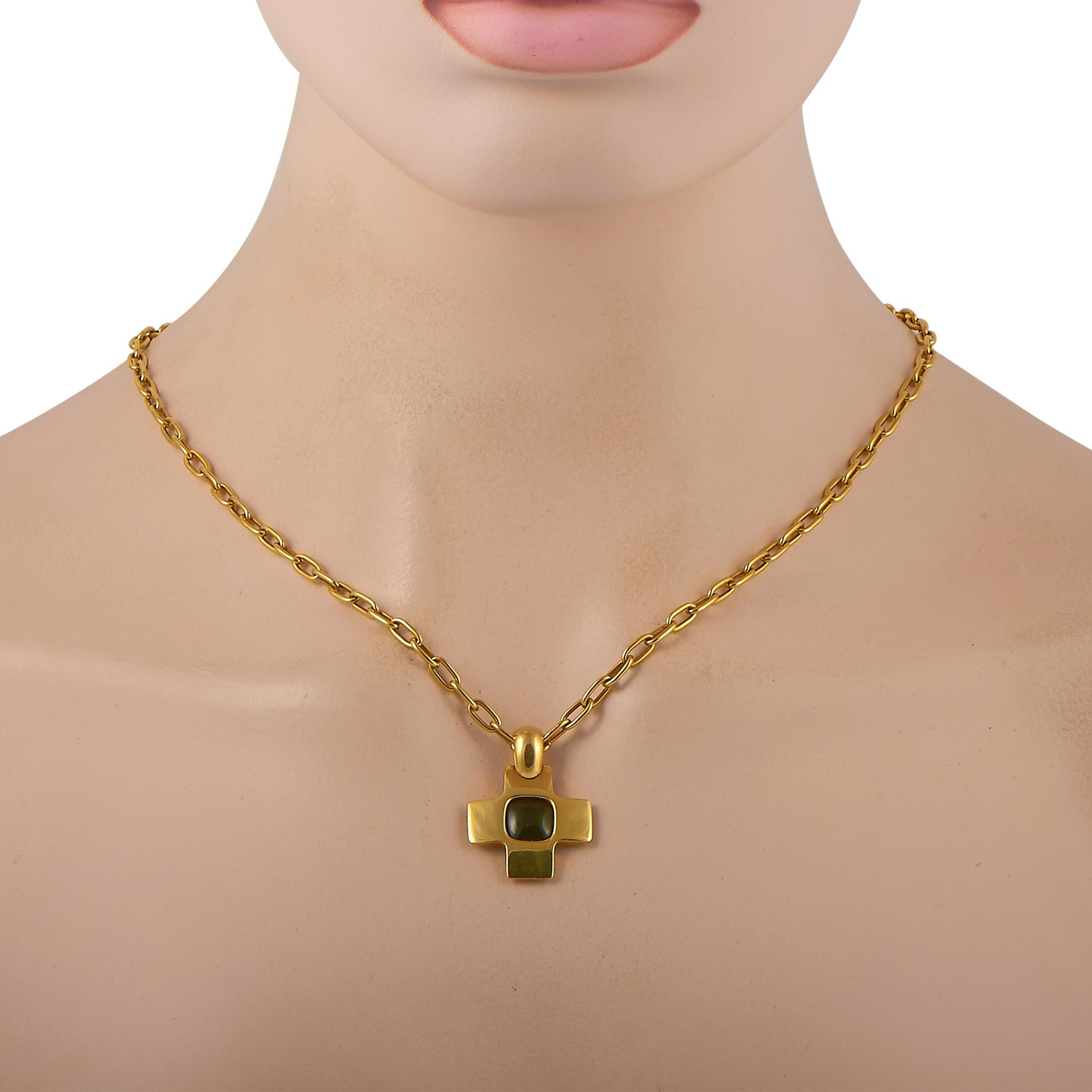 This Pomellato necklace is crafted from 18K yellow gold and embellished with a green tourmaline. The necklace weighs 33.5 grams and is presented with a 19” chain and a cross pendant that measures 1” in length and 1” in width.

Offered in estate