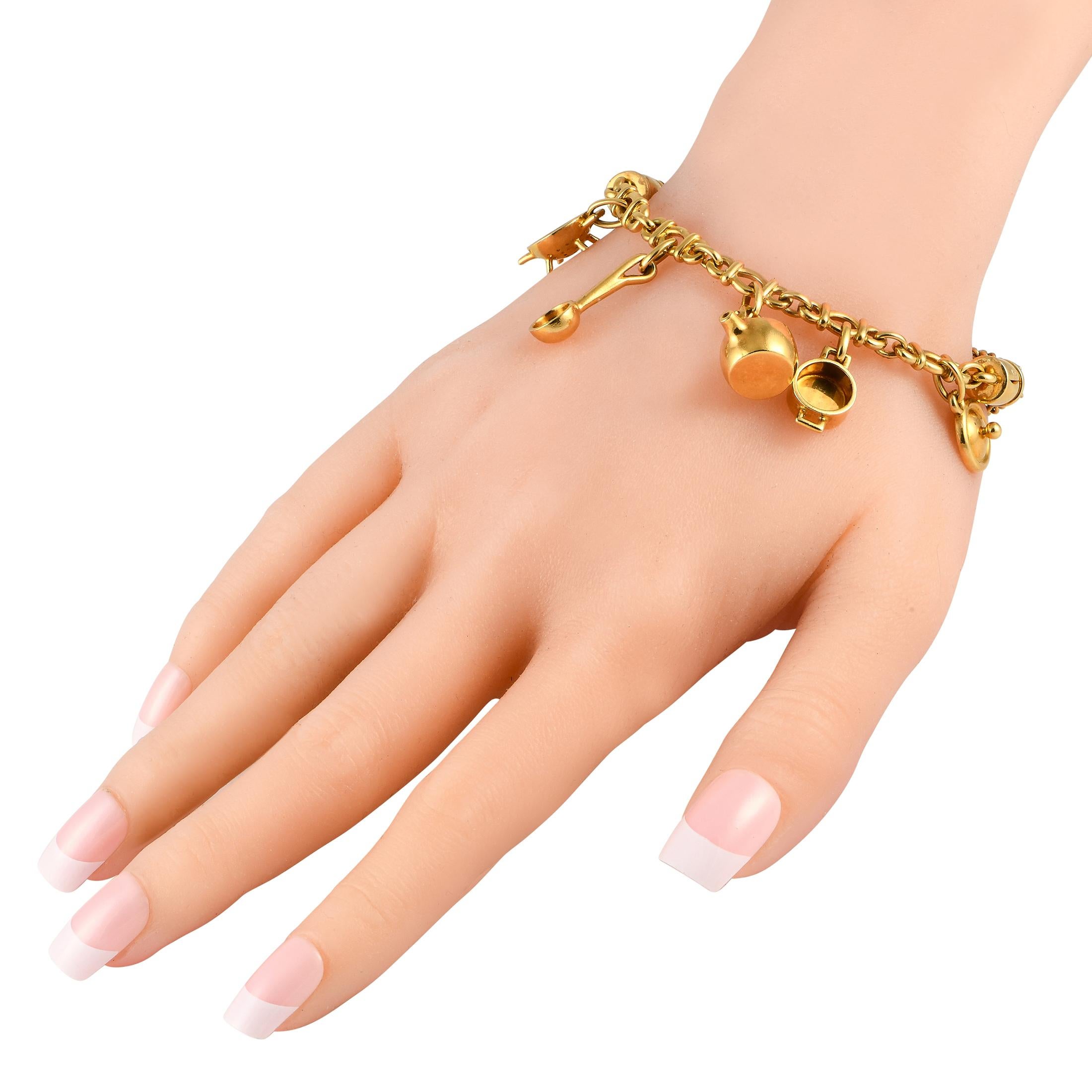 A series of kitchen inspired charms ensure this Pomellato charm bracelet will continually capture your imagination. Crafted from 18K Yellow Gold, this timeless piece features a bold chain base that measures 7.5 long.This jewelry piece is offered in