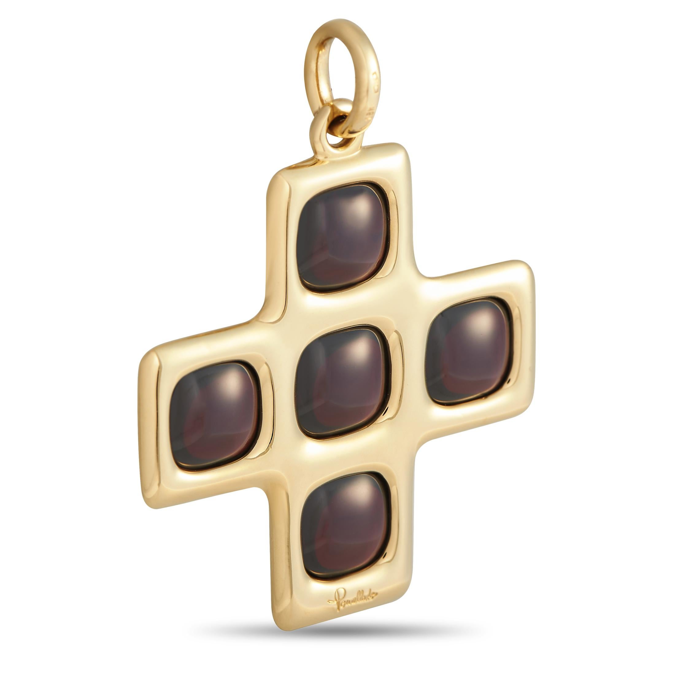 A bold and unconventional jewel from luxury Italian jewelry maker, Pomellato. This cross pendant measures 2.25 by 1.55 inches and features a smooth and polished finish, detailed with five smooth and domed garnet cabochons.This signed Pomellato 18K